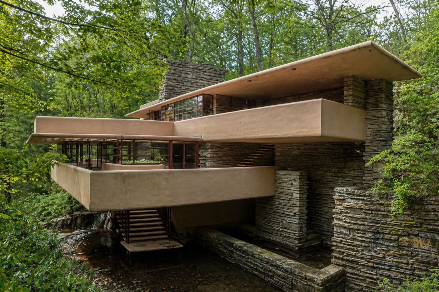 Frank Lloyd Wright’s Fallingwater house with cantilevered terraces, stone walls, and a wooded stream setting.