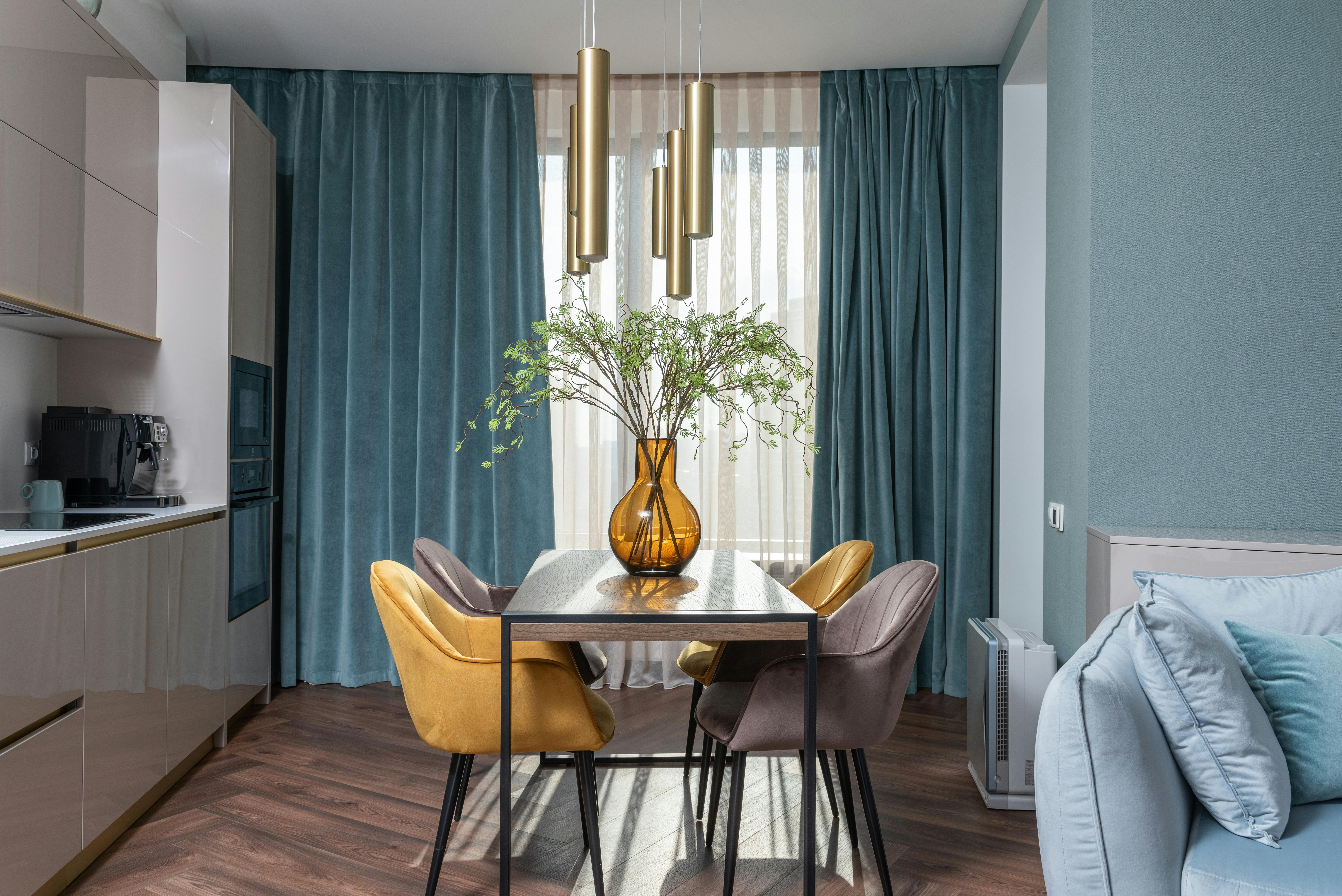 Small space interior with smart layout fitting sofa, chairs, and dining table.