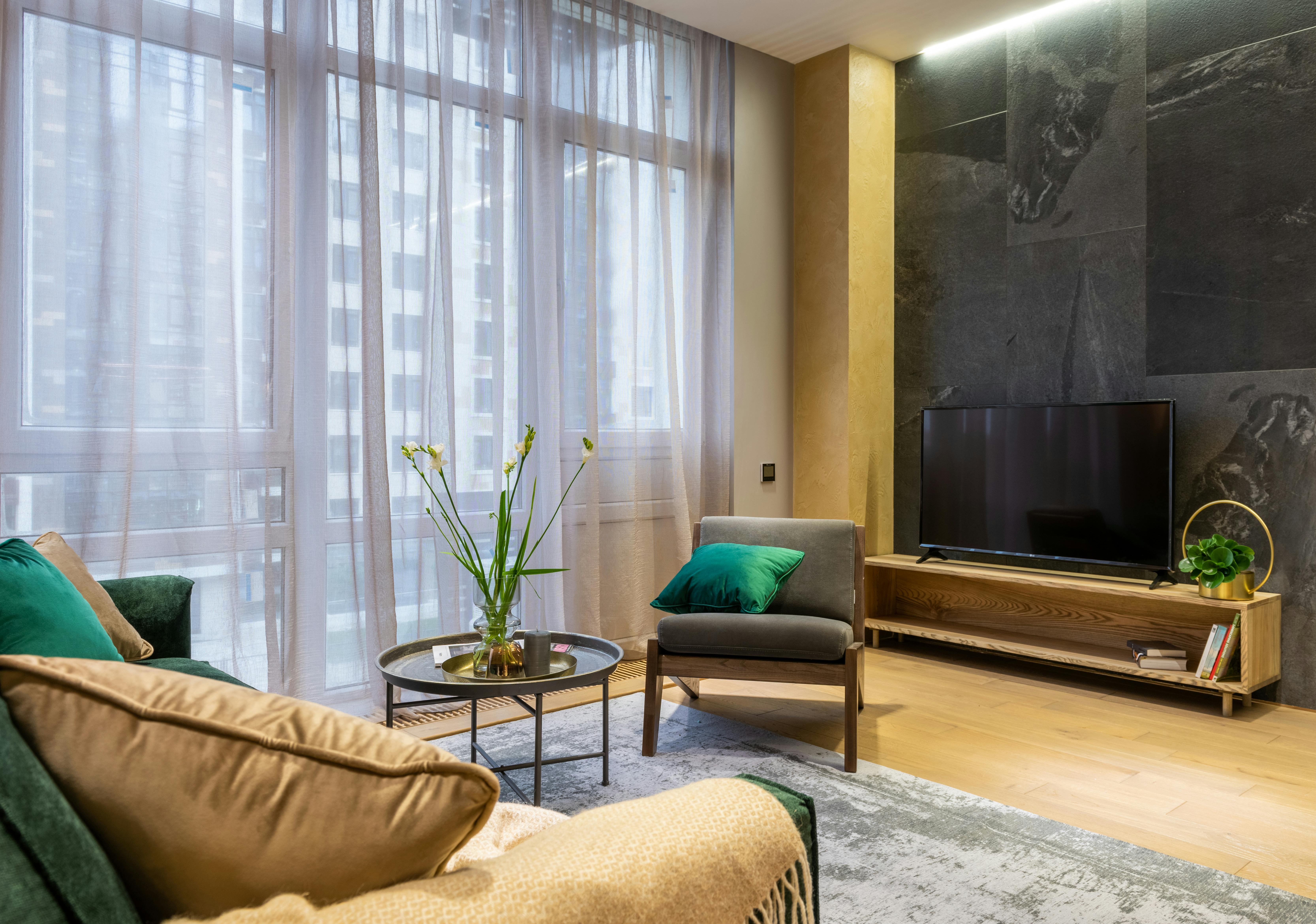 Interior design featuring grey and yellow with green accents.