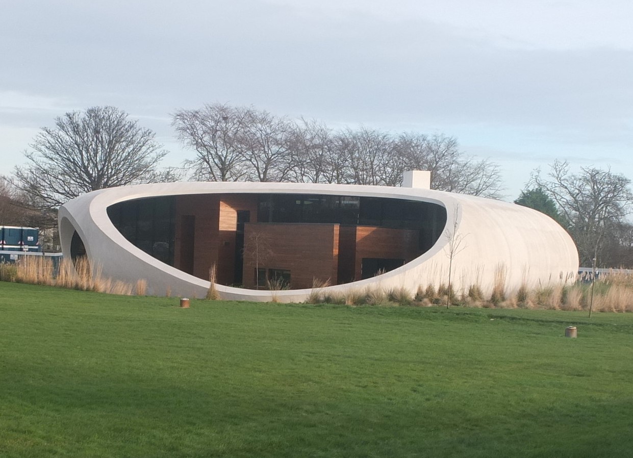Human-centered healthcare building with wood cladding and curved walls.