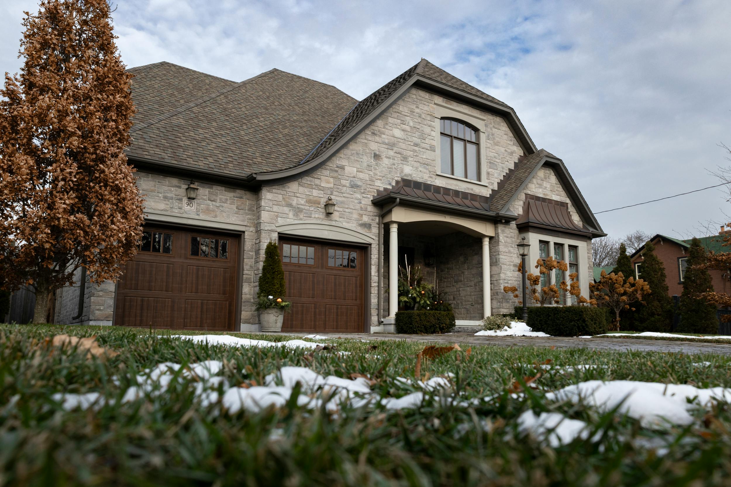 Ground-level view of a luxury home exterior blending modern and classic elements.