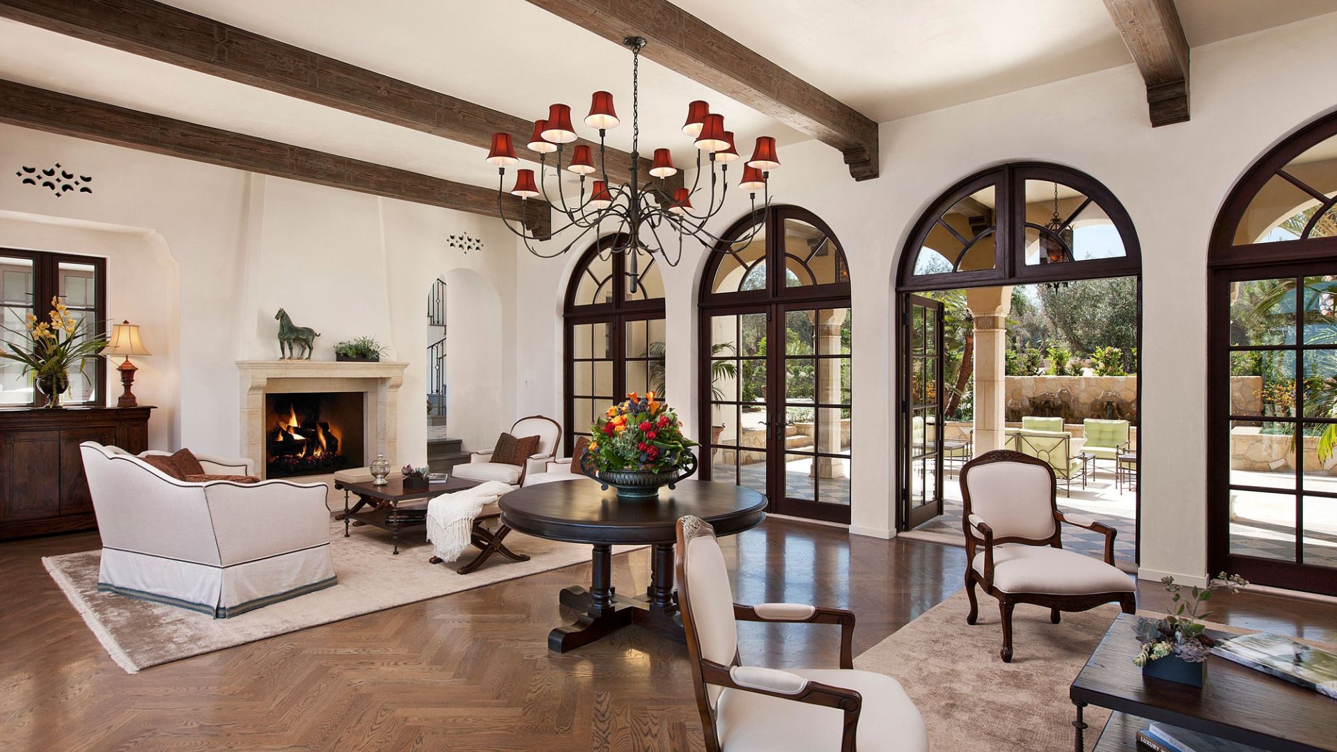 Spanish Colonial style living room with fireplace in Mediterranean villa.
