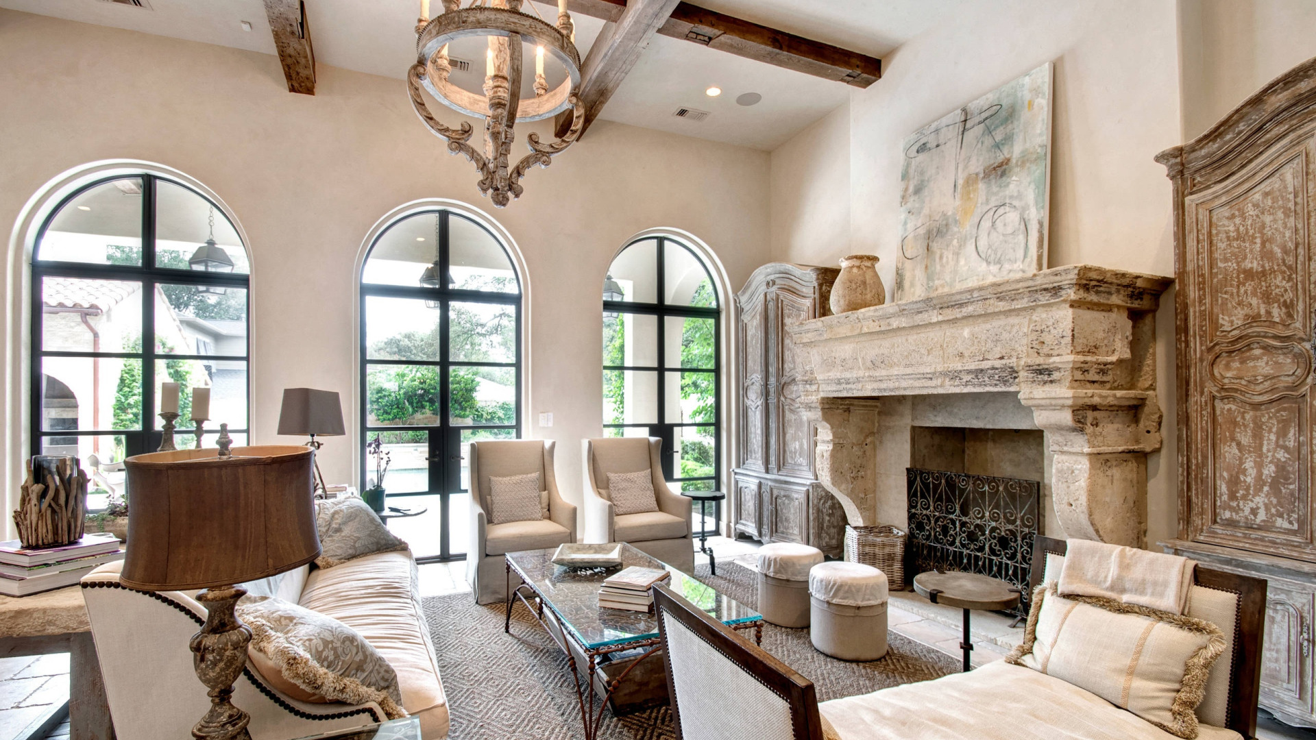 Mediterranean villa living room with fireplace and rustic decor.