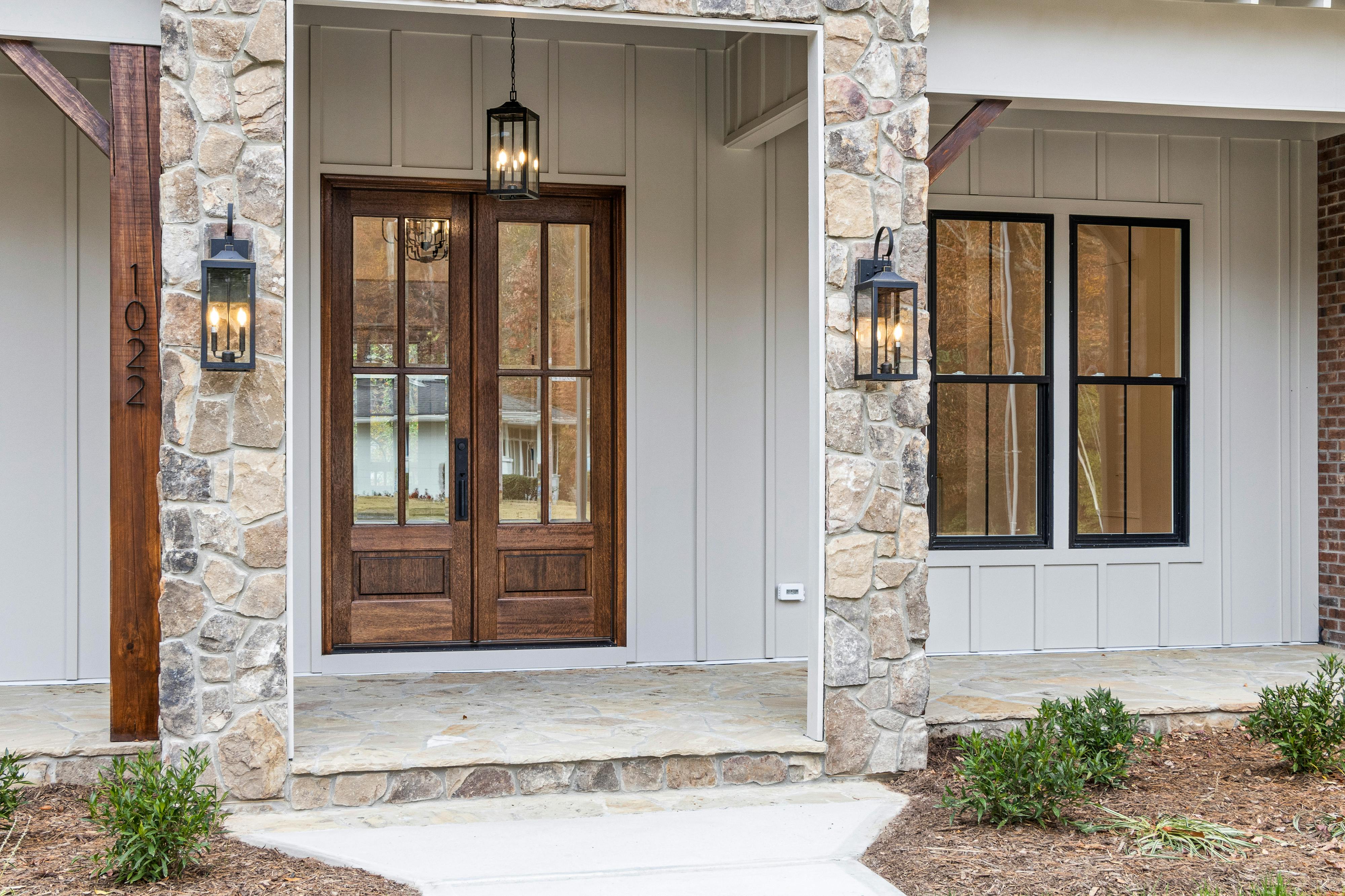 Modern farmhouse exterior with visible entrance and simple architectural lines.