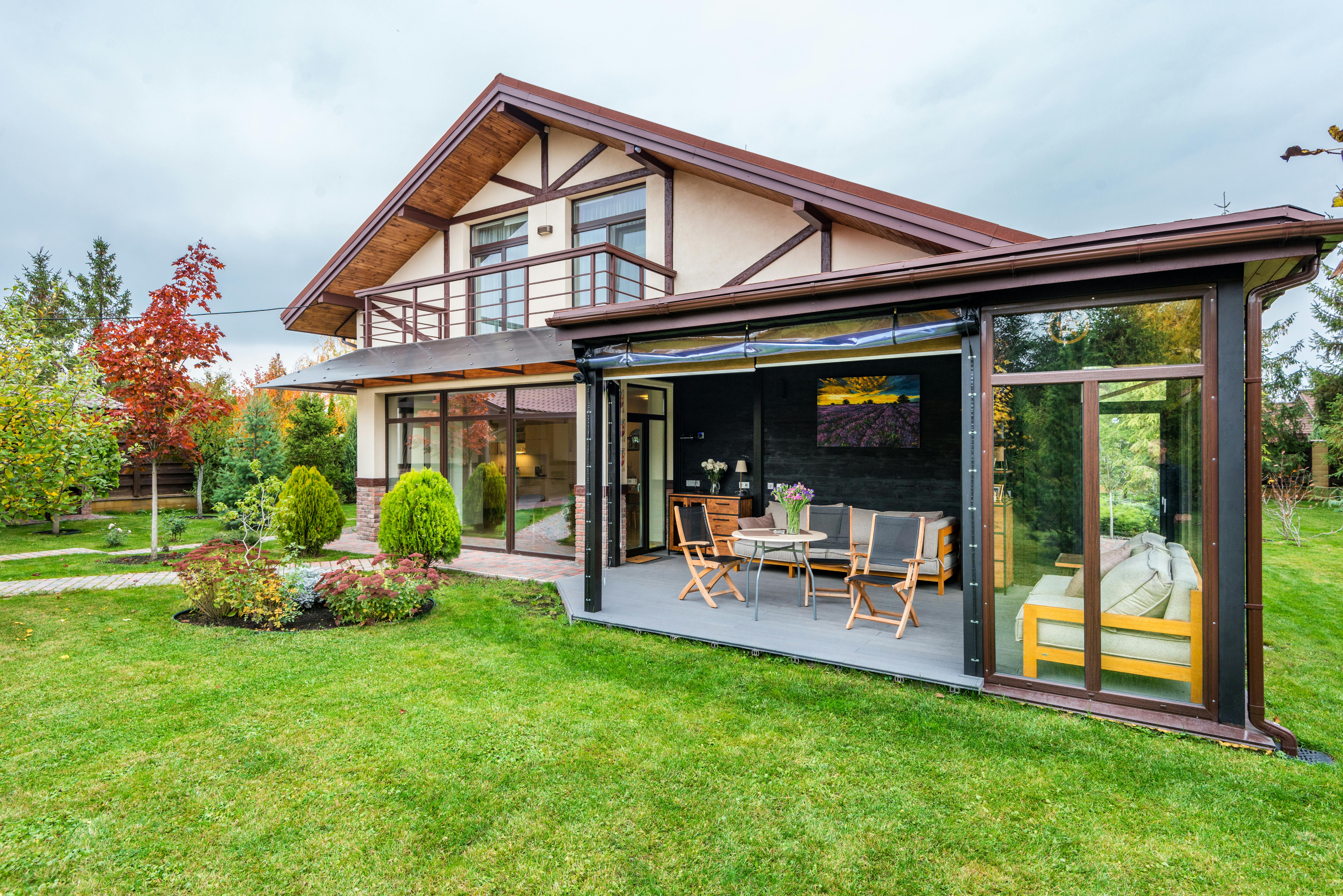 Modern house with mostly one-level layout and extended upper section.