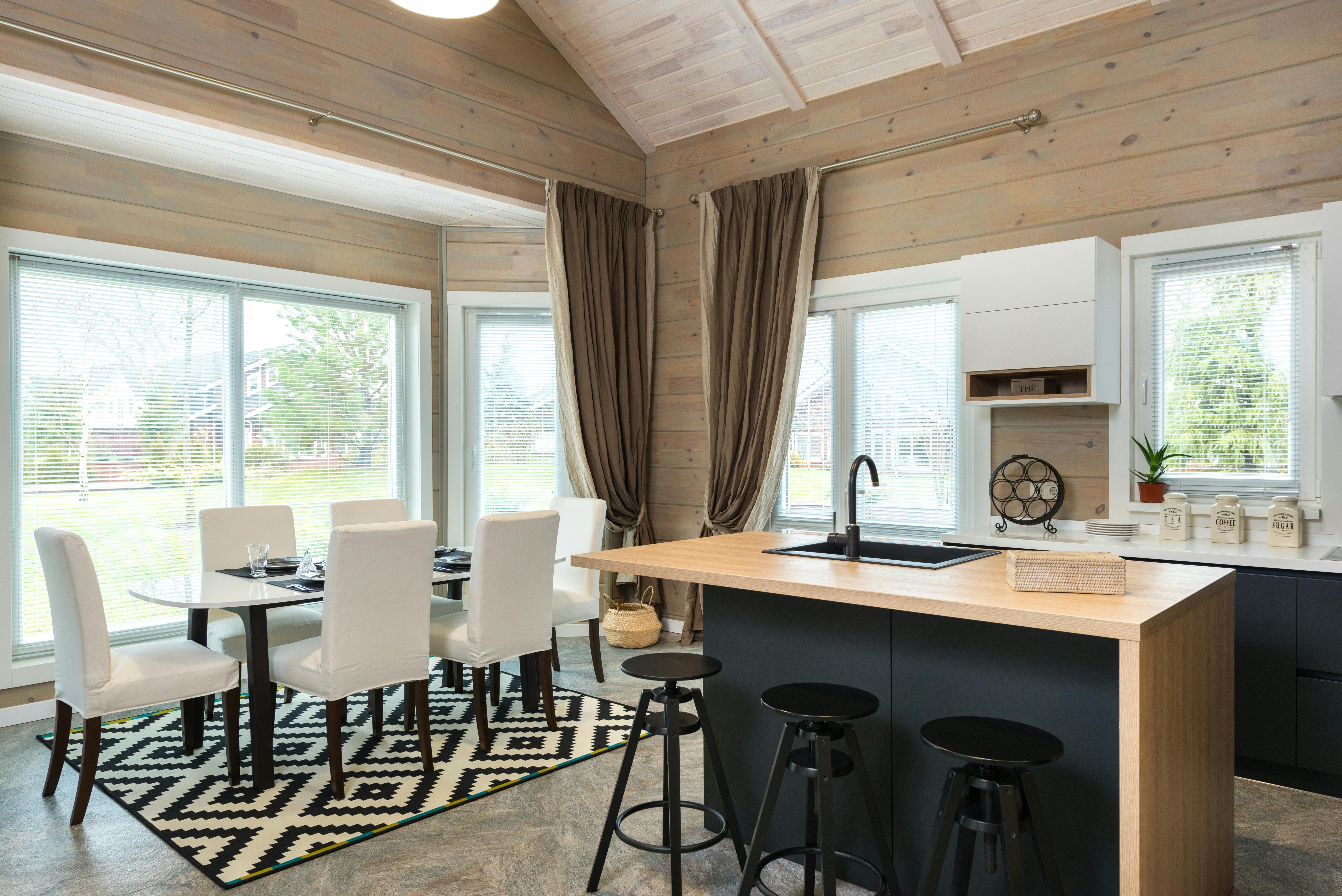 Modern home with large windows, clean lines, and a small minimalist kitchen.