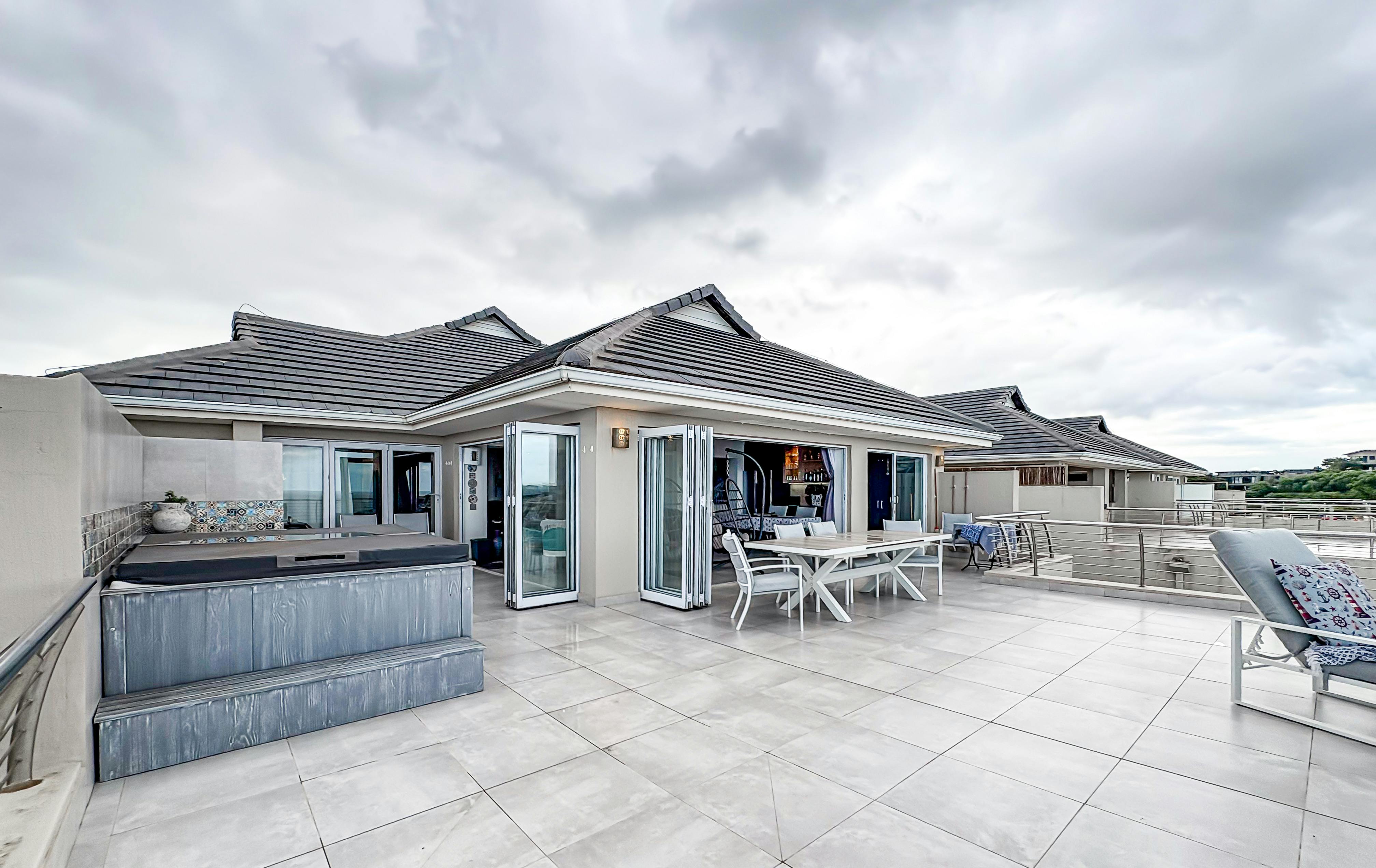 Modern house terrace with open design overlooking the ocean.
