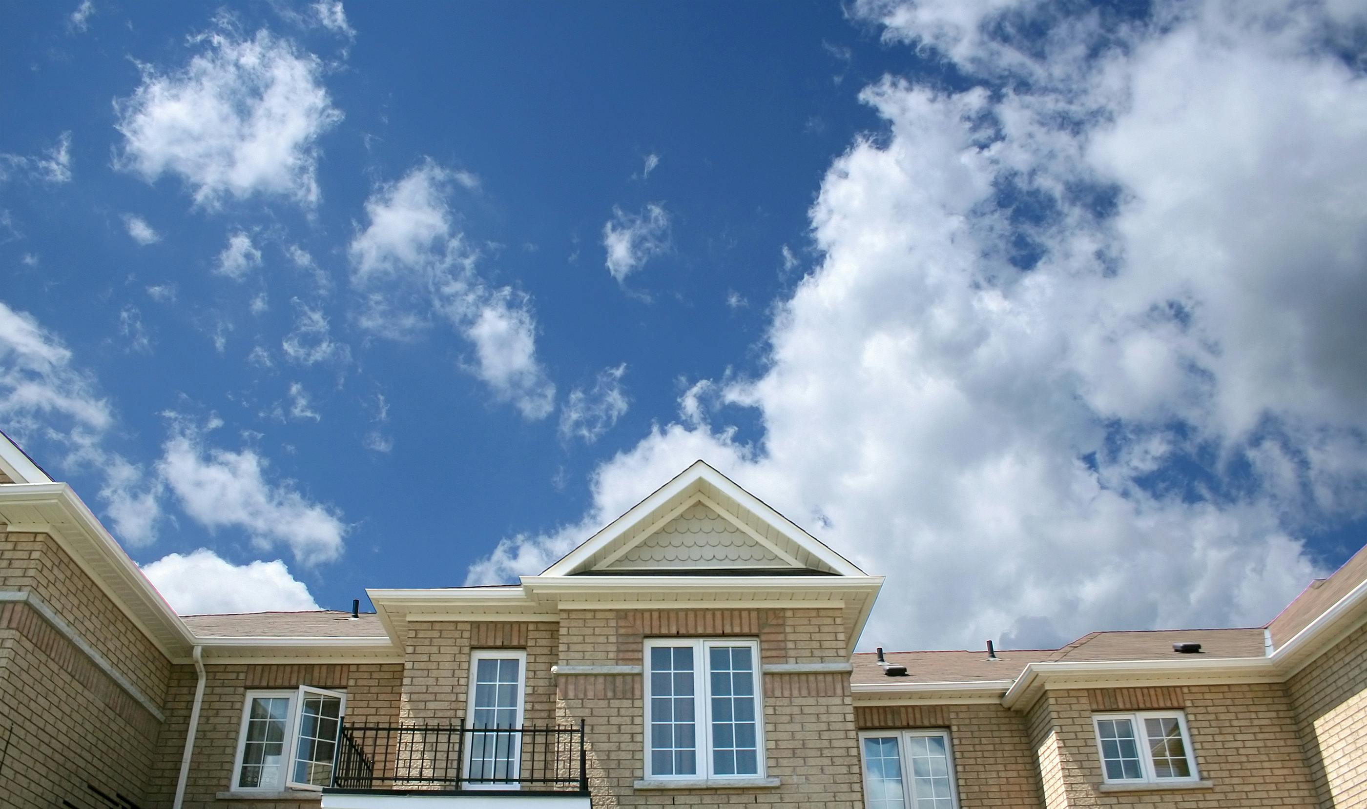 Modern stone facade of a large house with clean, subtle design.