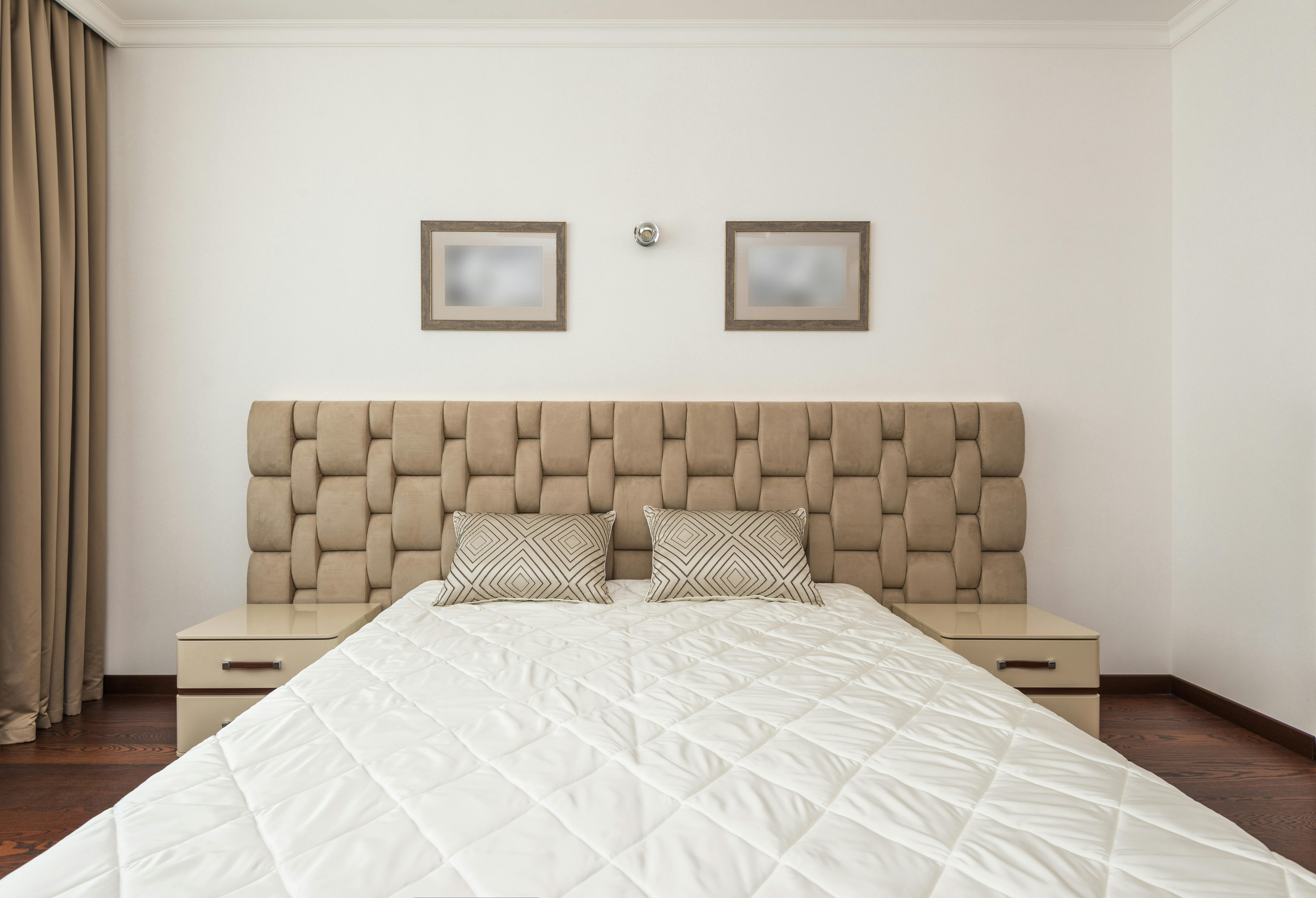 Bedroom interior with neutral tones, soft furnishings, and calming design.