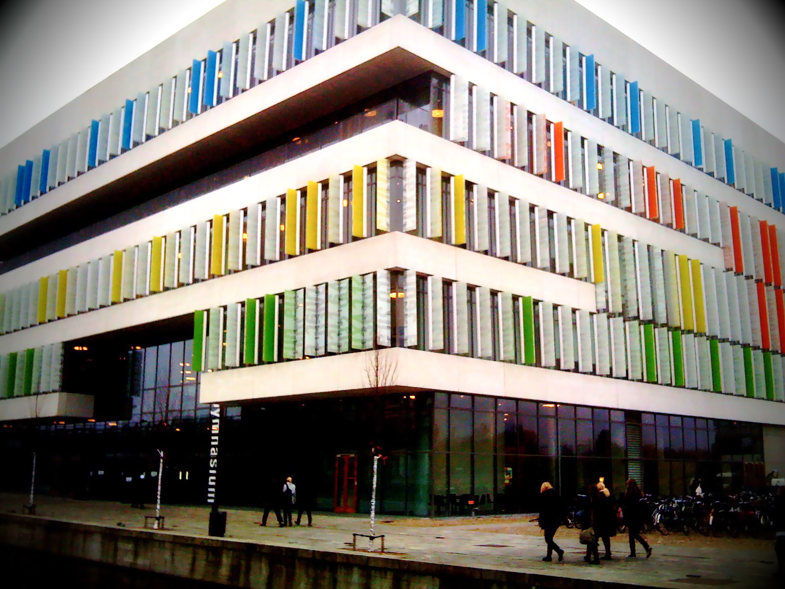 Exterior of Ørestad Gymnasium with glass facade and angular form.
