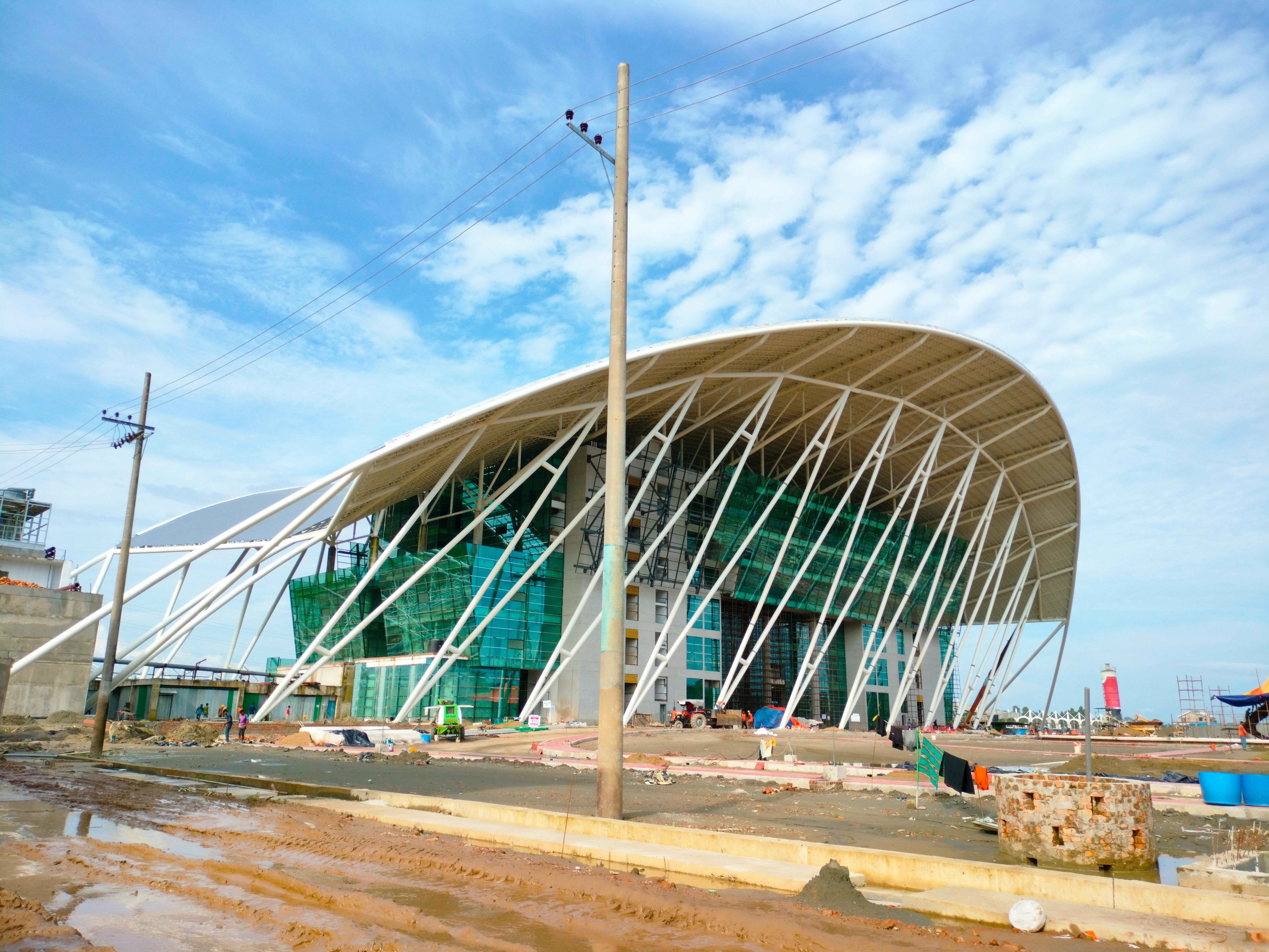 Steel truss installation in progress at a modern public transport terminal under construction.