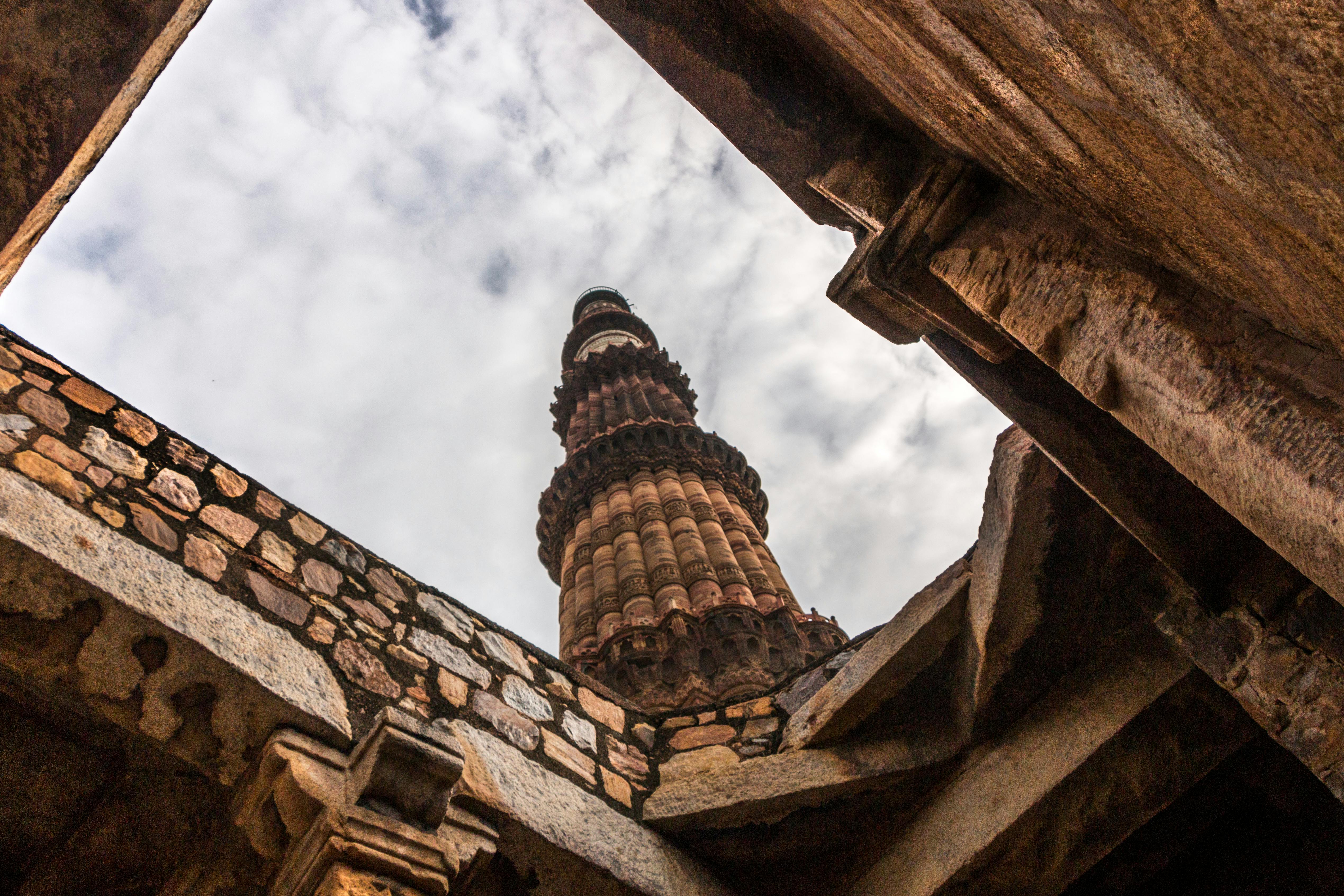 Qutub Minar featuring alternating red sandstone and marble layers in India.
