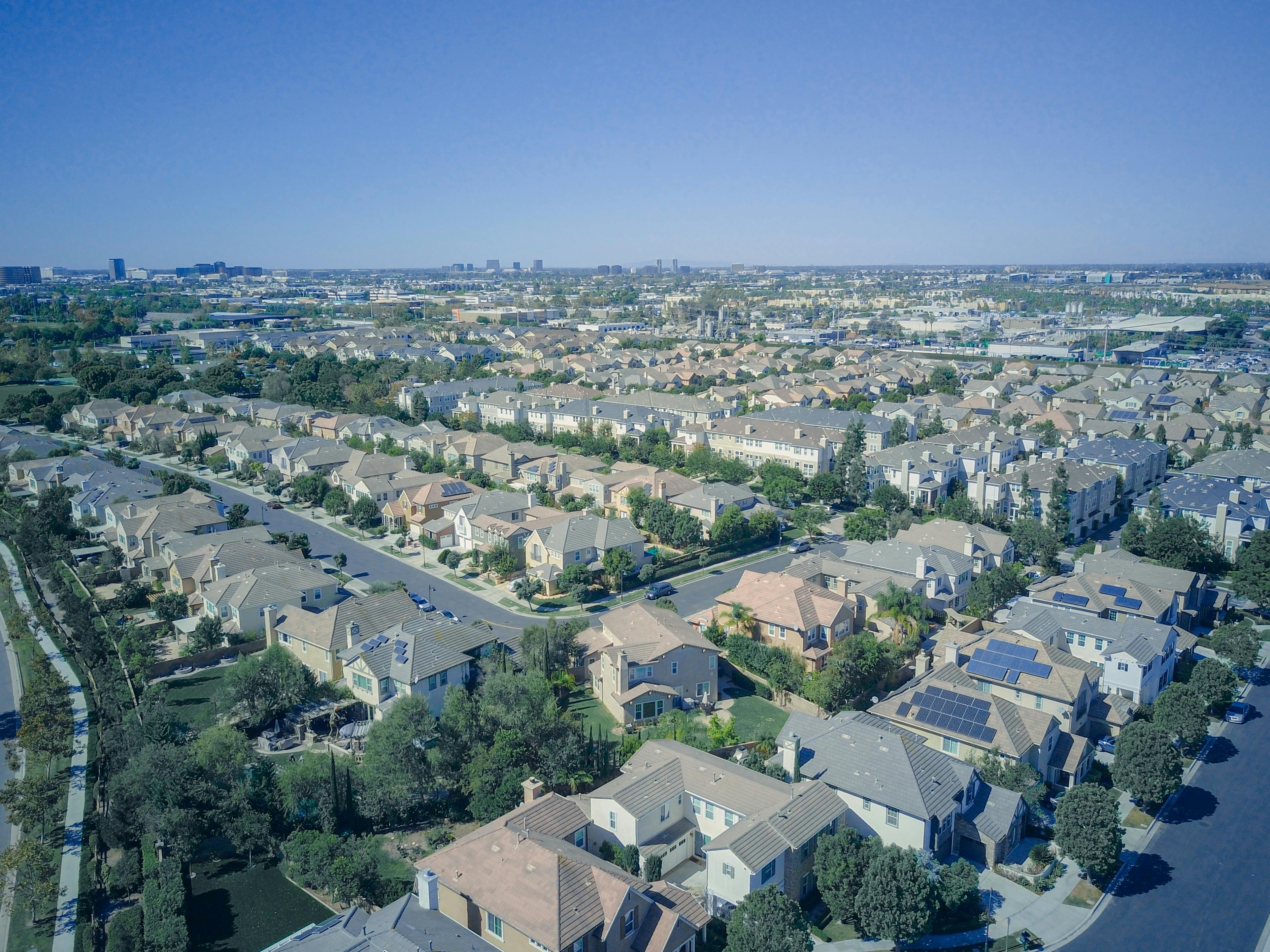 Aerial view of U.S. neighborhood with multiple homes featuring rooftop solar panels.