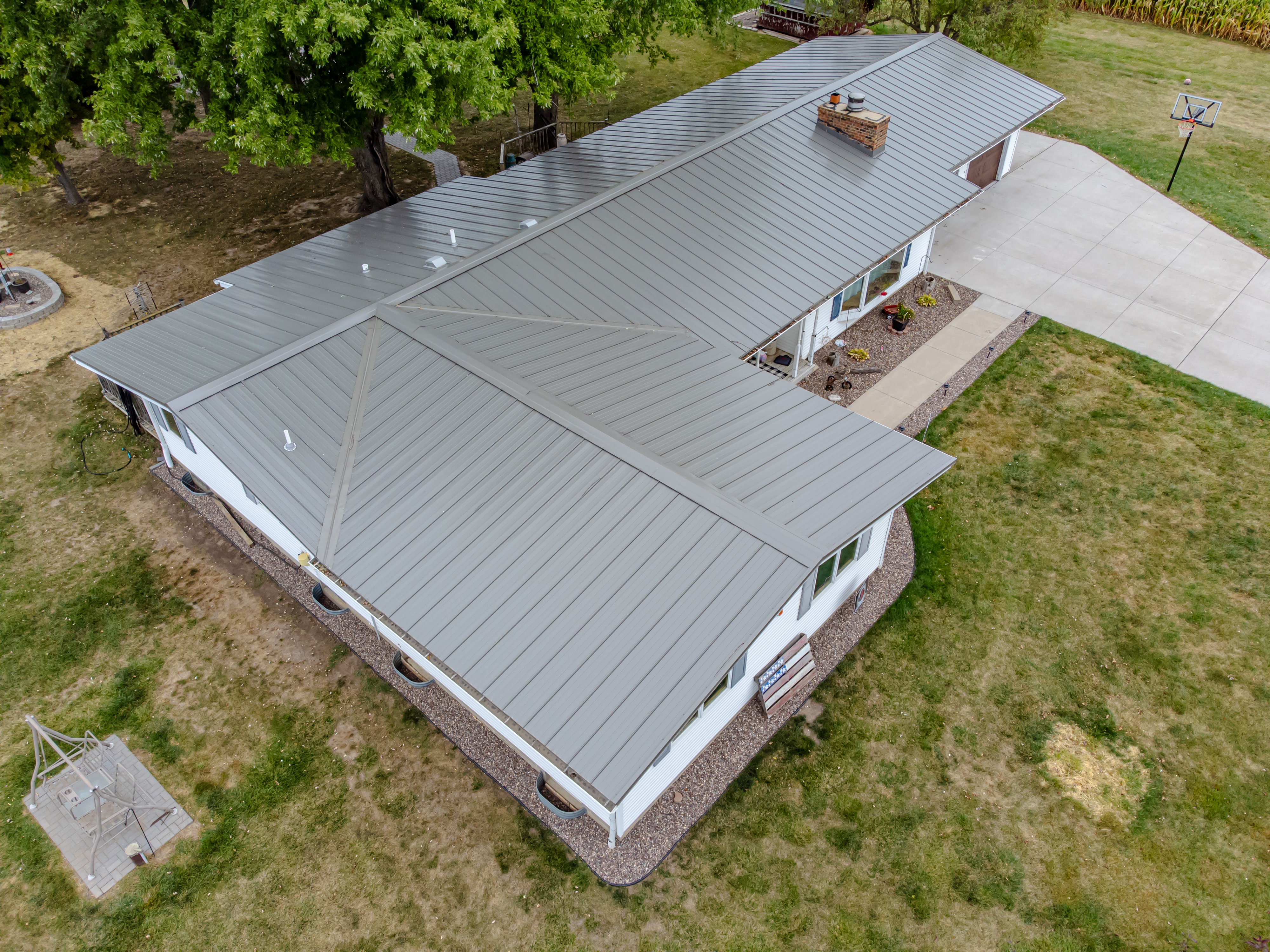 Low-pitch roof with standing seam metal panels.