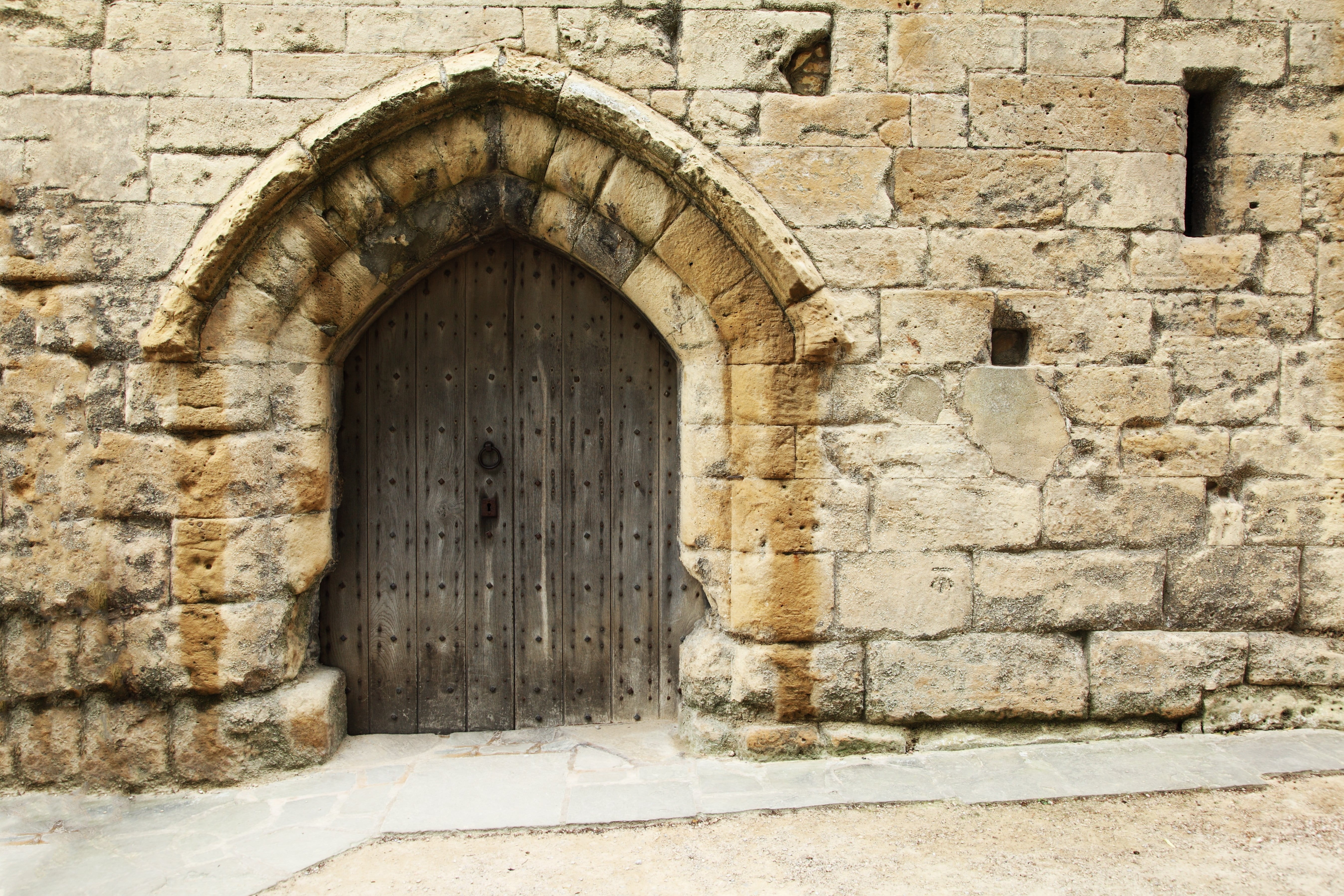 Old stone castle gate with arched entrance and historic architecture.