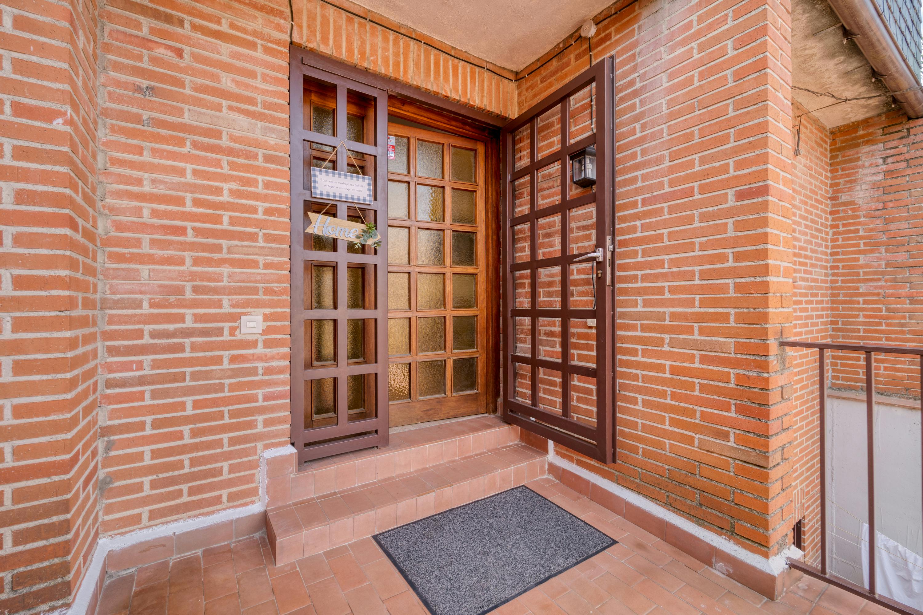 Wooden door set into a brick and stone house entrance.