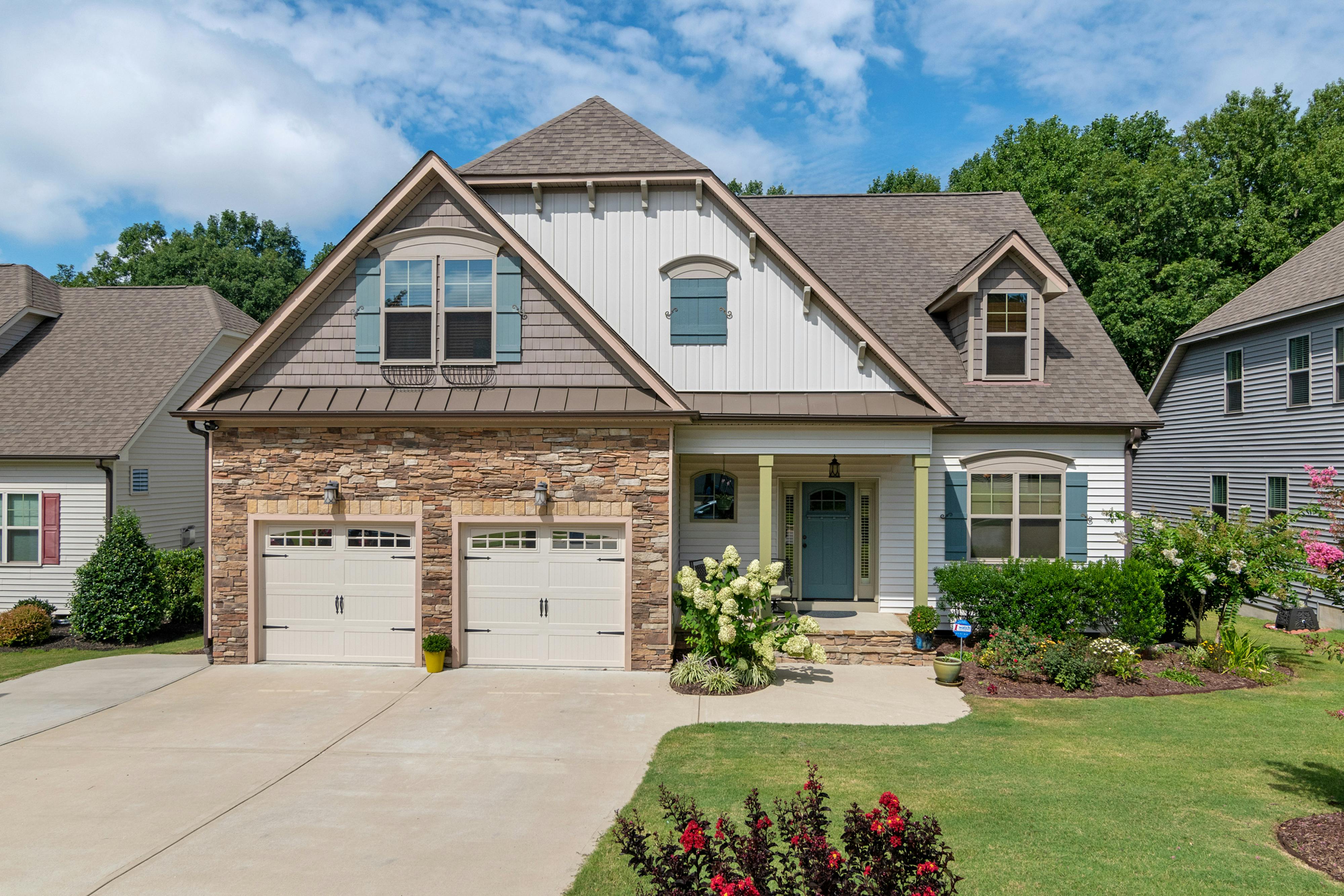 House facade blending traditional stonework with modern design elements.
