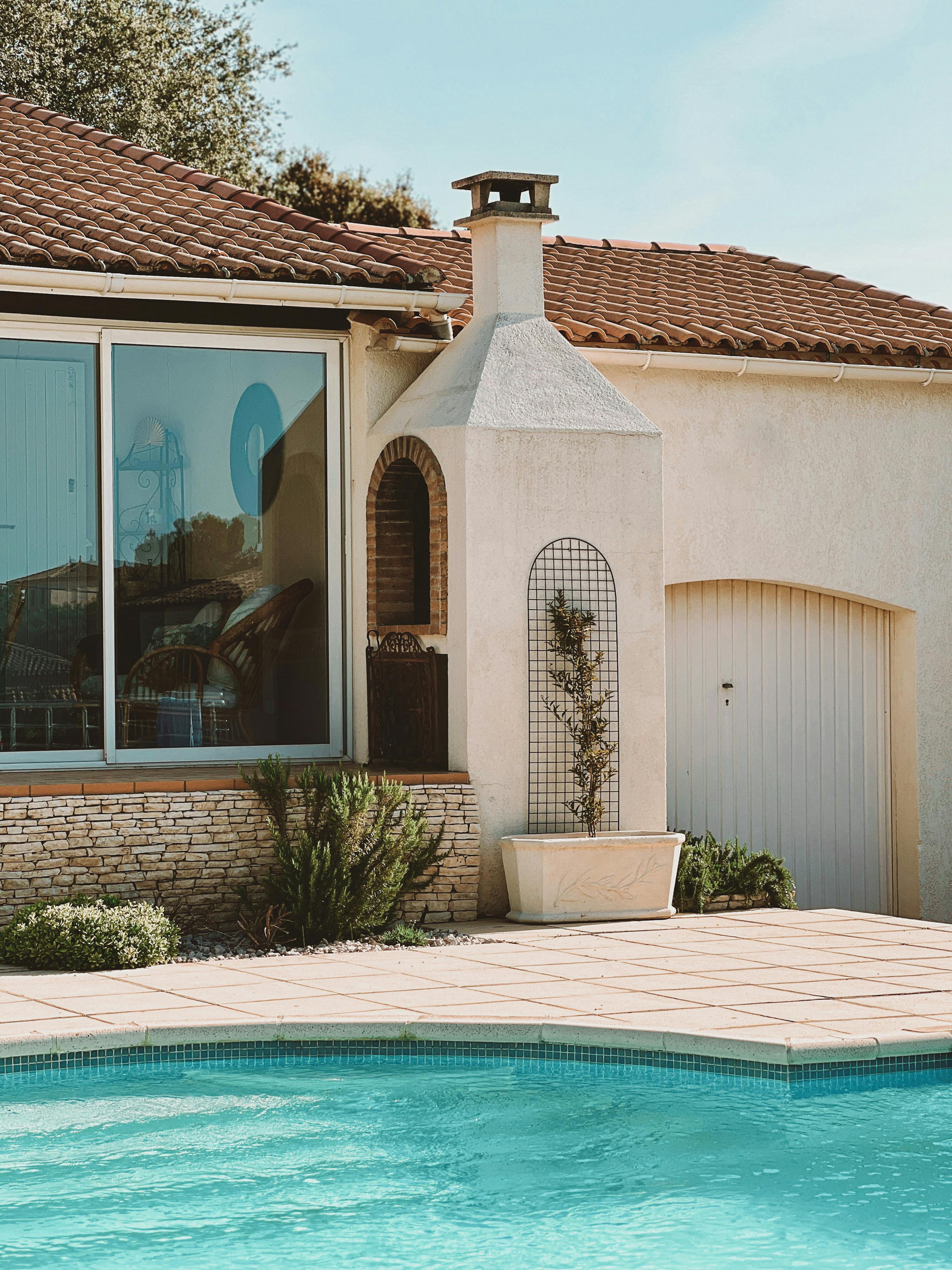 Mediterranean villa with stucco walls and pool.