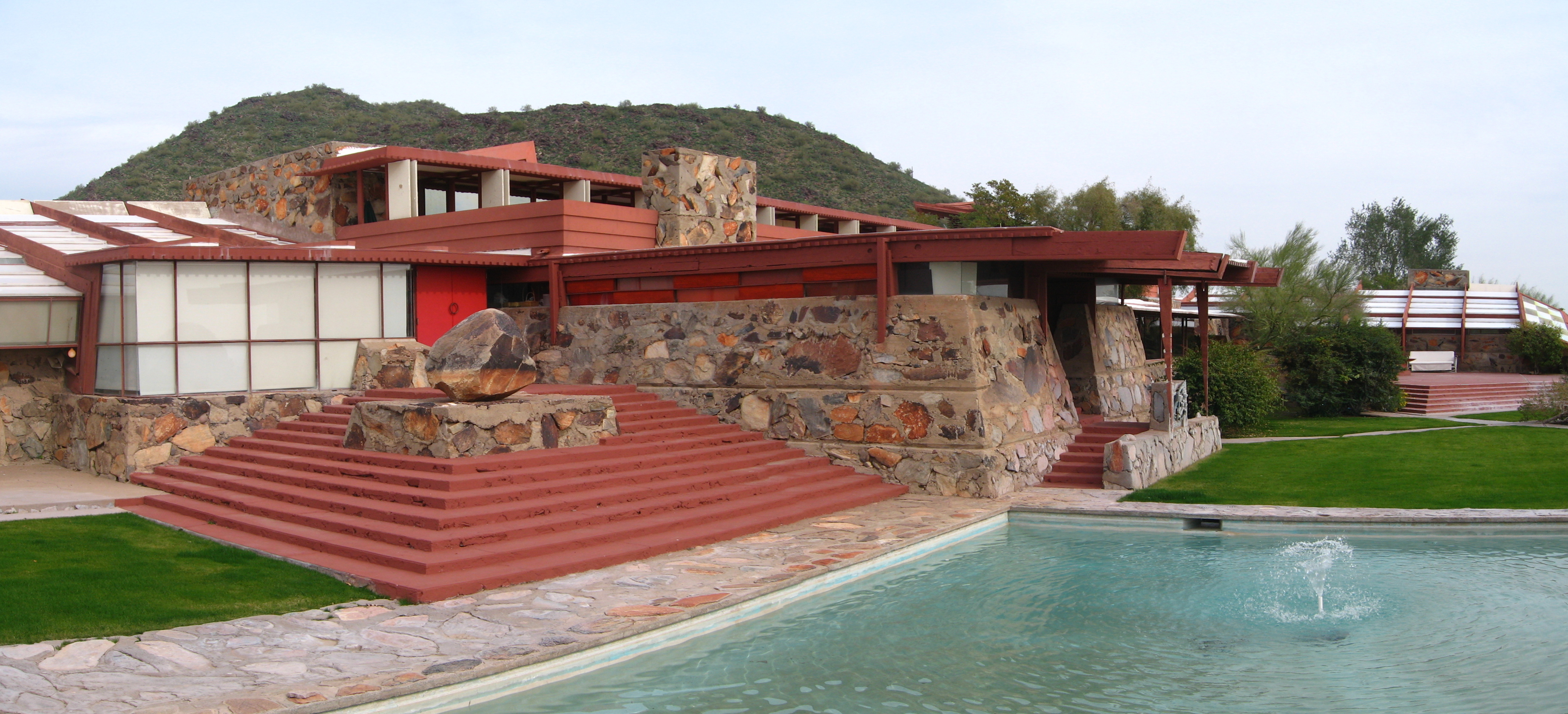 Taliesin West in Arizona, designed by Frank Lloyd Wright as his winter home and architectural studio, blending native stone, redwood, and desert landscape into a cohesive organic design.