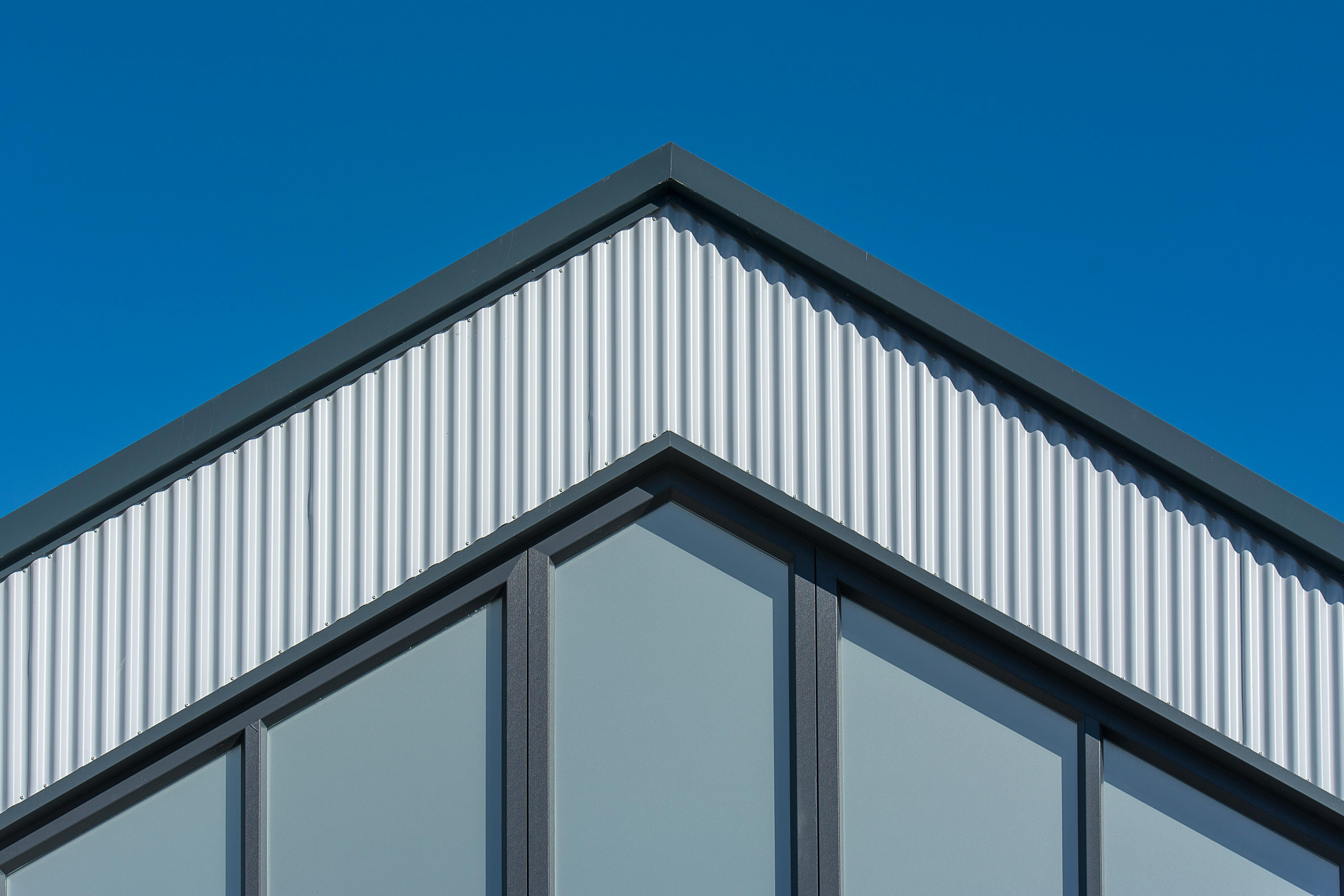 Simple modern facade with triangular top, elegant and affordable design.