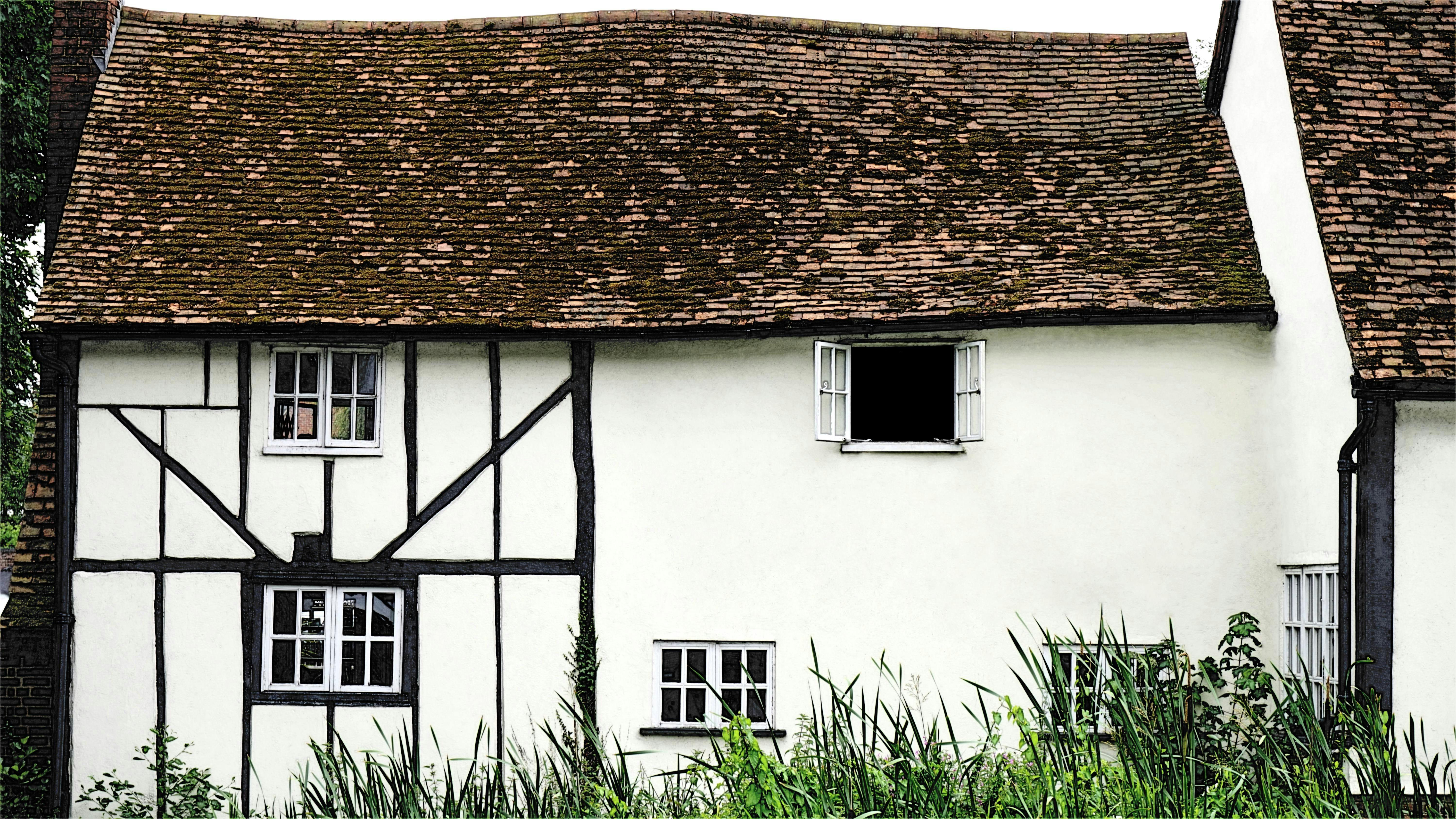 Old Tudor house with traditional stone facade and timber details.