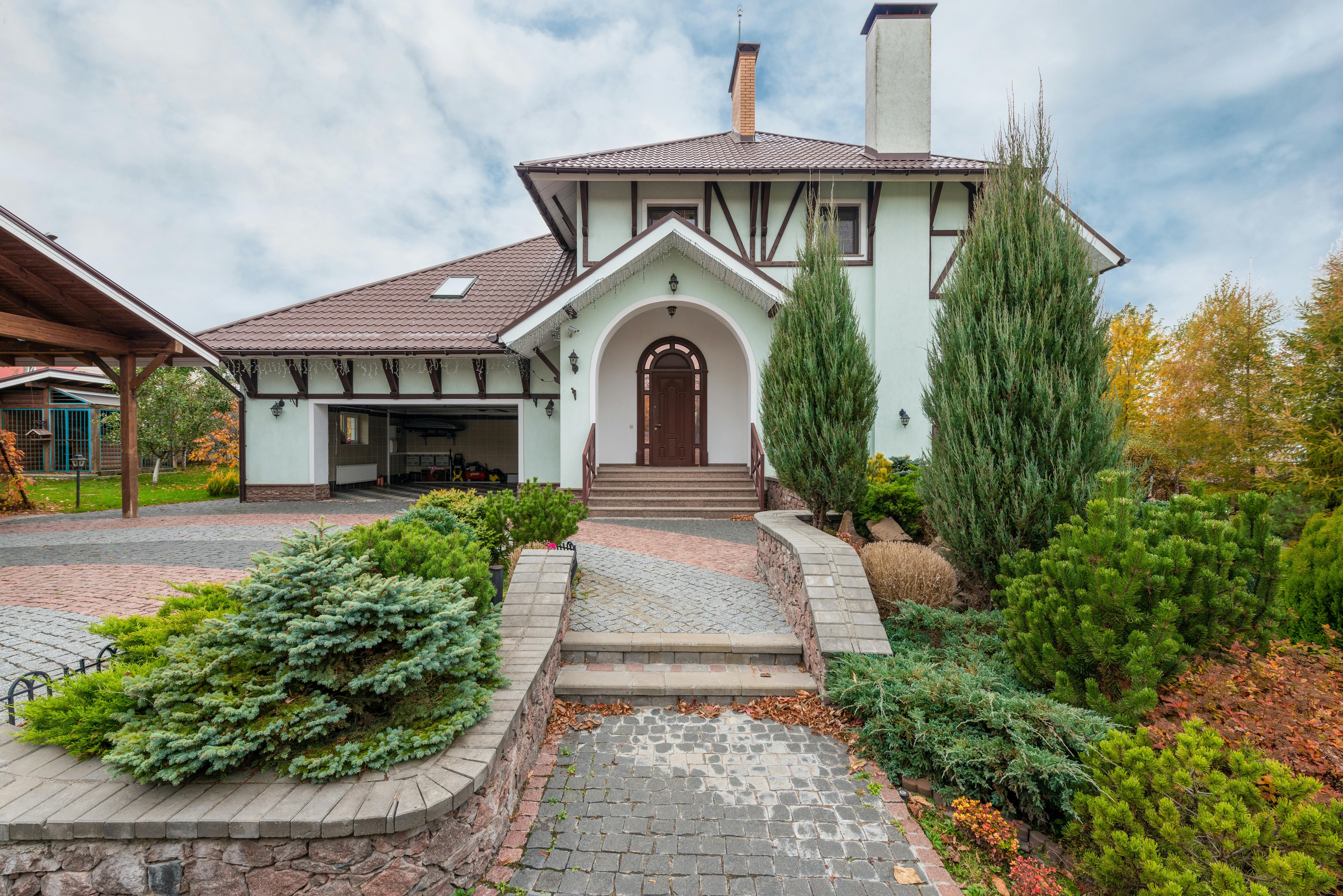 Tudor-style house featuring classic stone masonry and traditional architectural details.