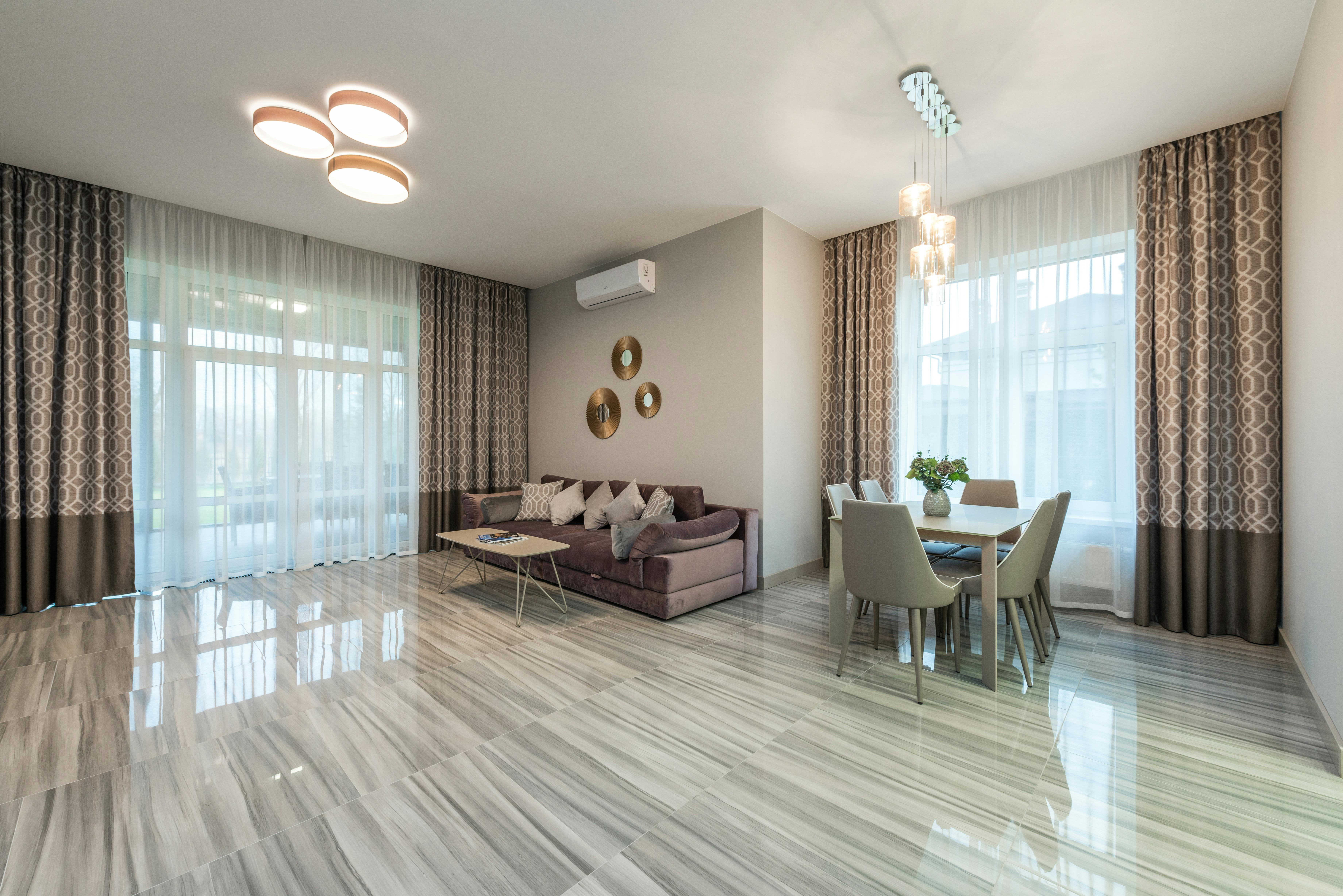 Large room with sparse furniture and cold lighting.