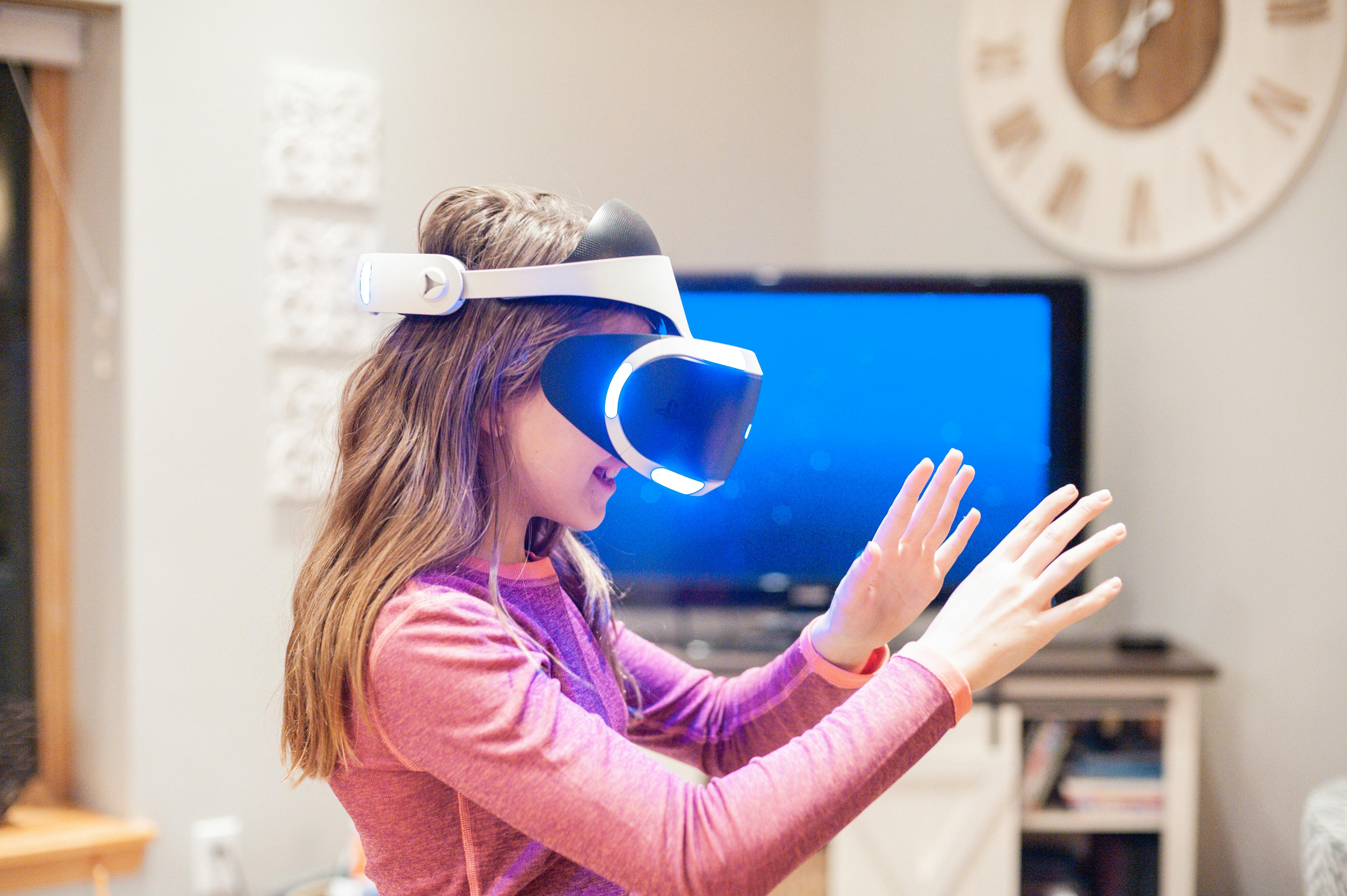 Child wearing VR goggles in a modern smart home interior.