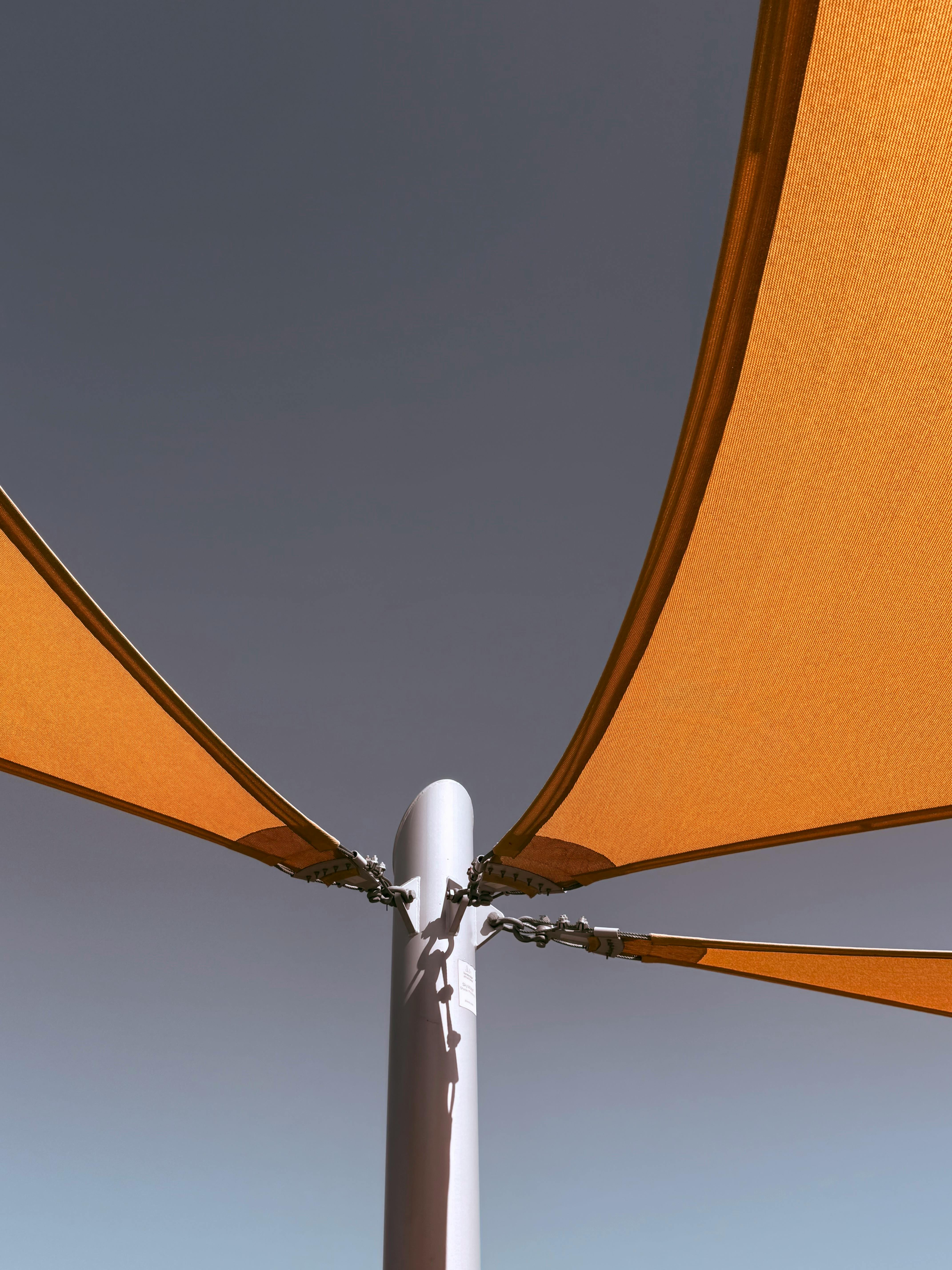 Modern minimalist outdoor canopy with central pole.