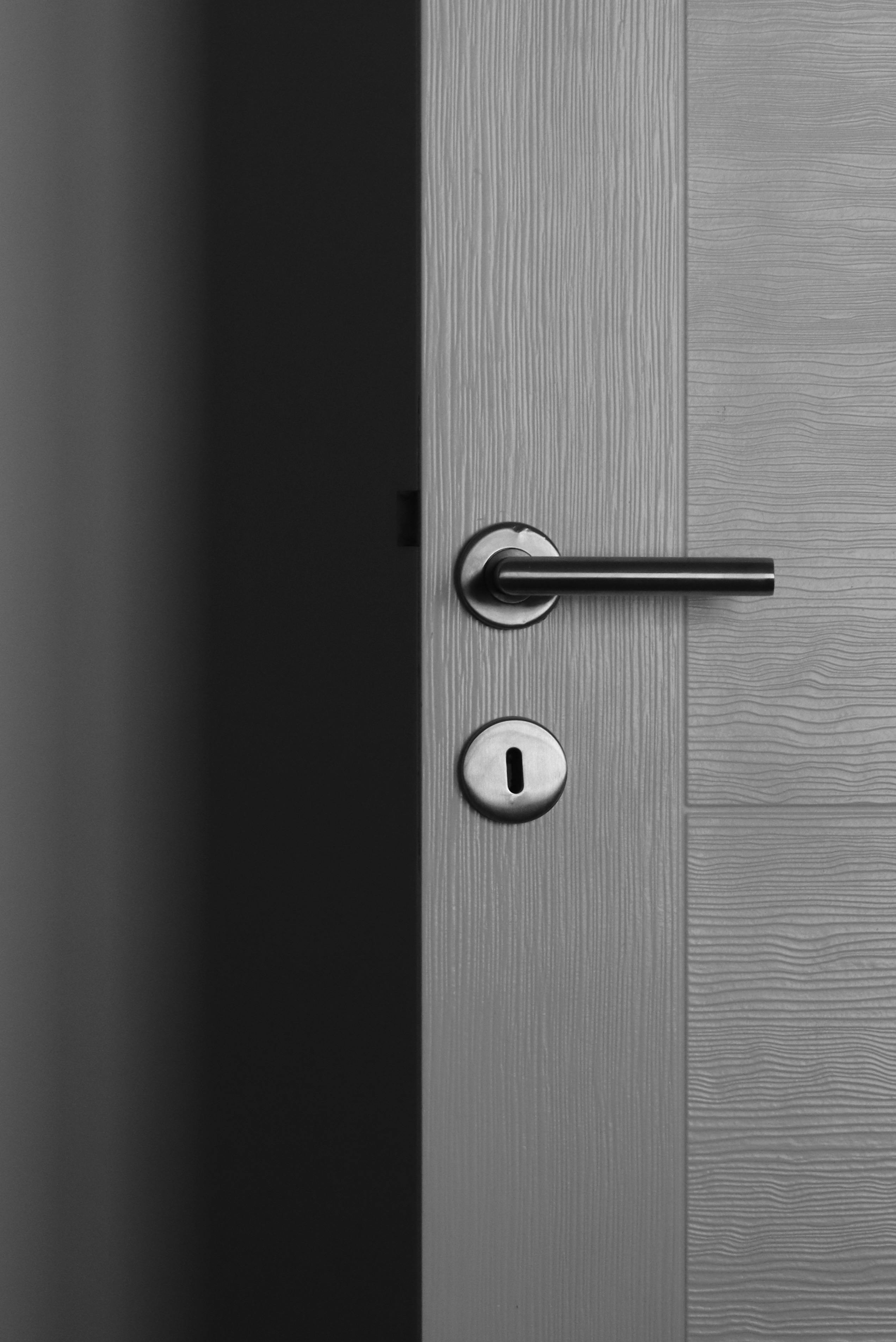 Gray Masonite exterior door with lever handle in a modern home.