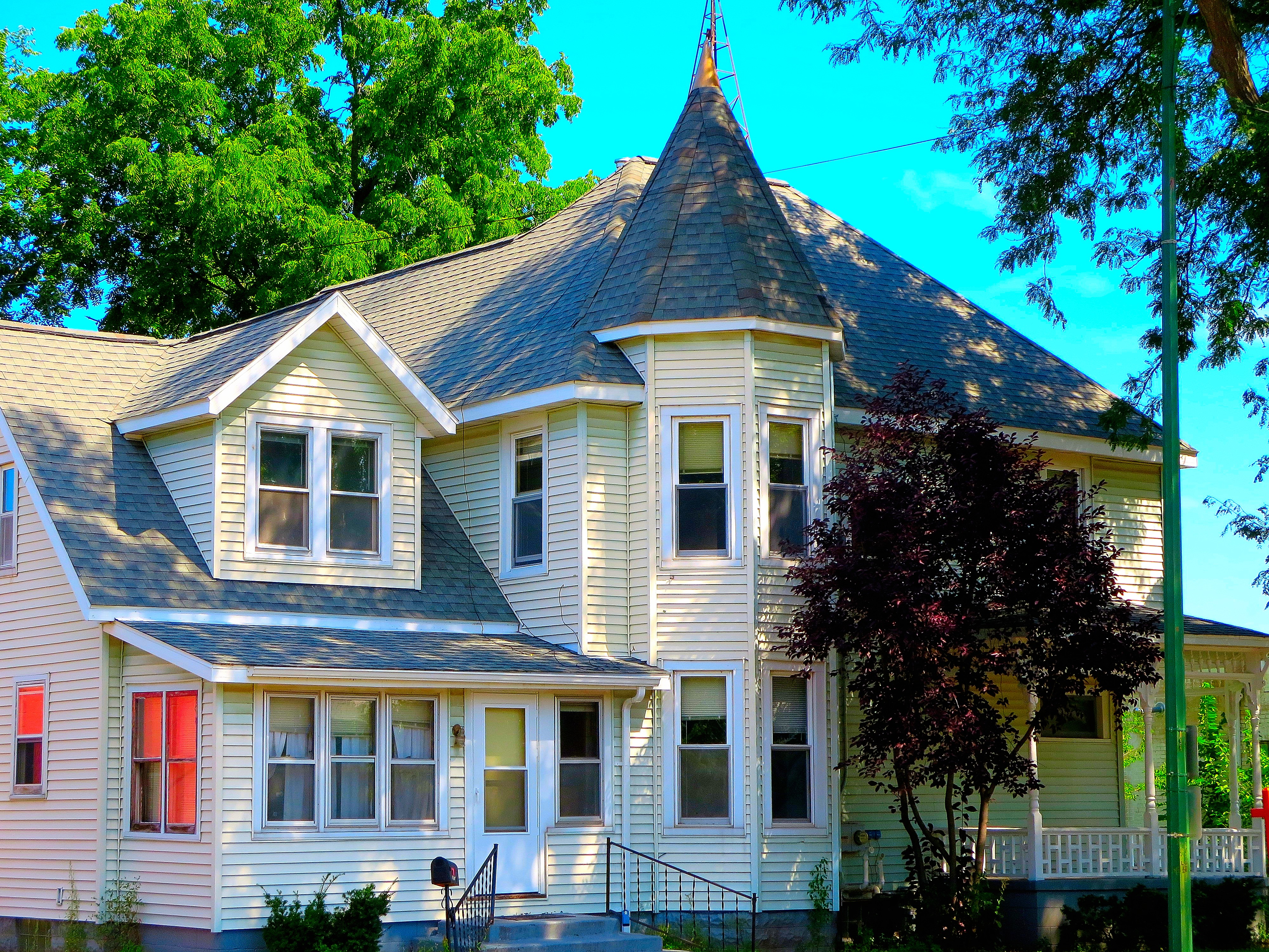 Single Queen Anne style house with turret.