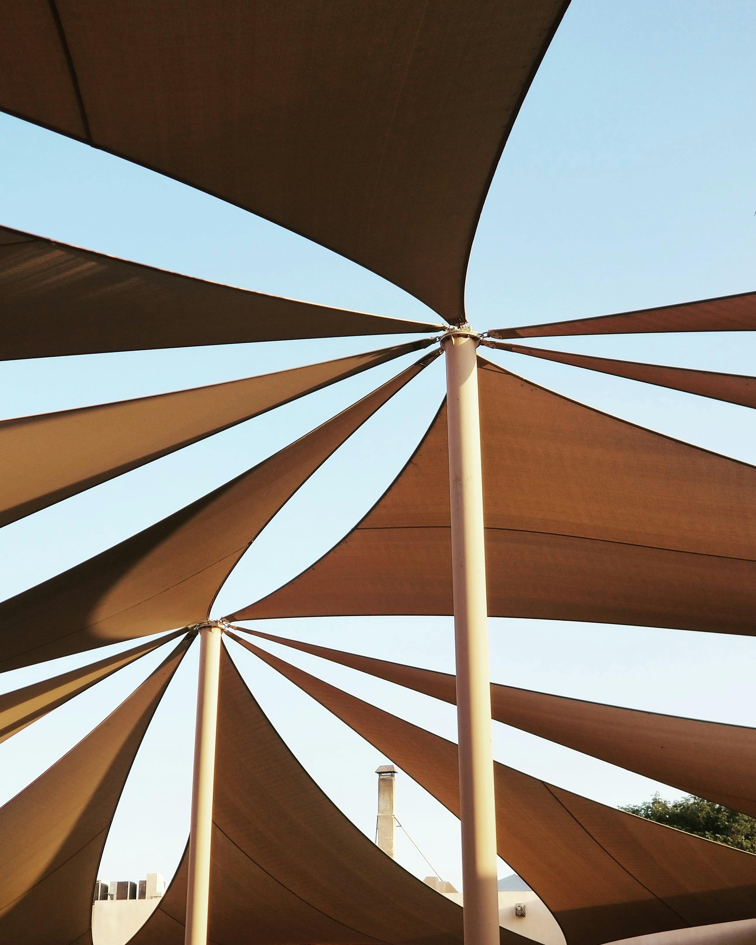 Sleek outdoor canopy with multiple poles in minimalist style.