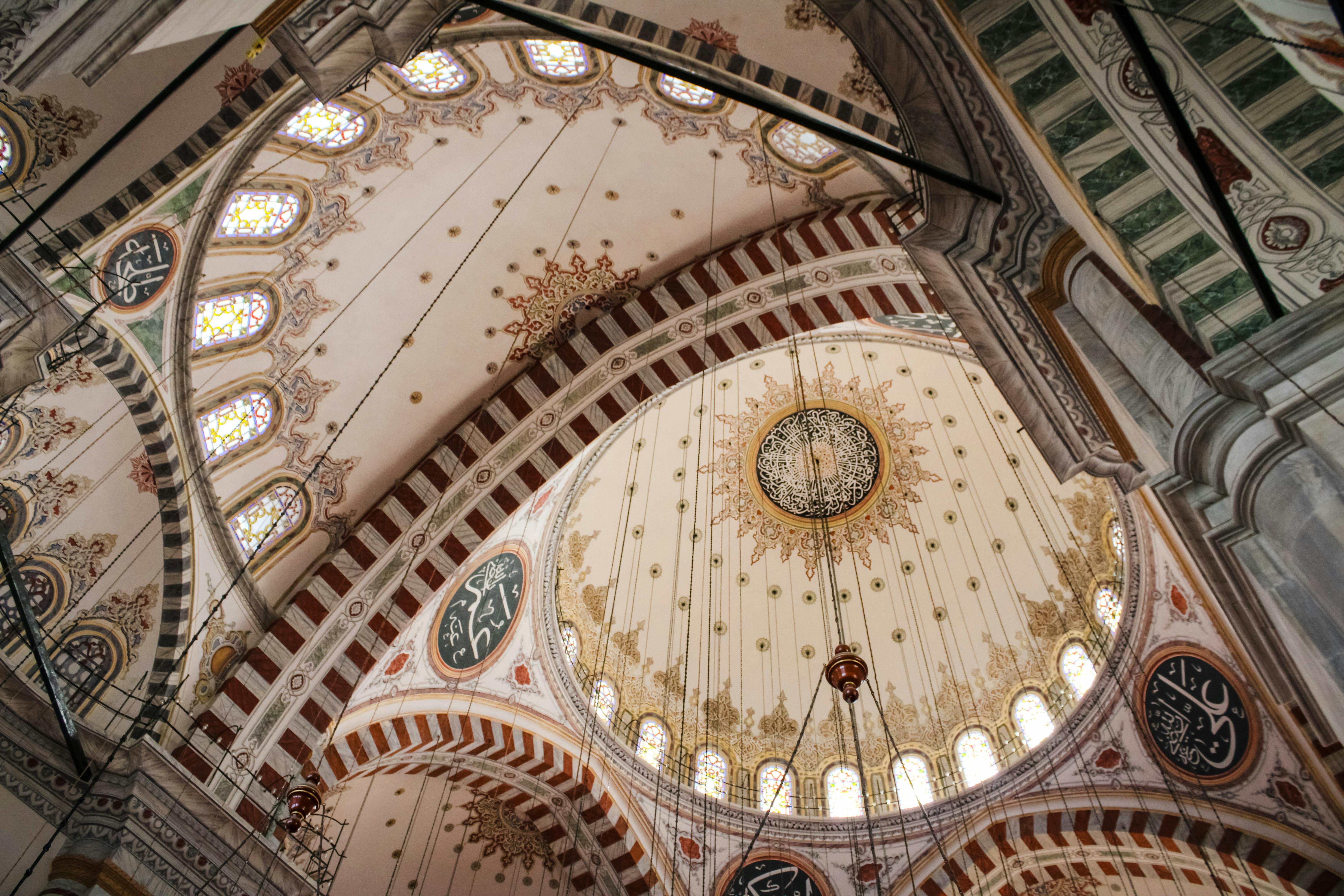 Ornate ceiling of the Süleymaniye Mosque in Istanbul with intricate patterns.