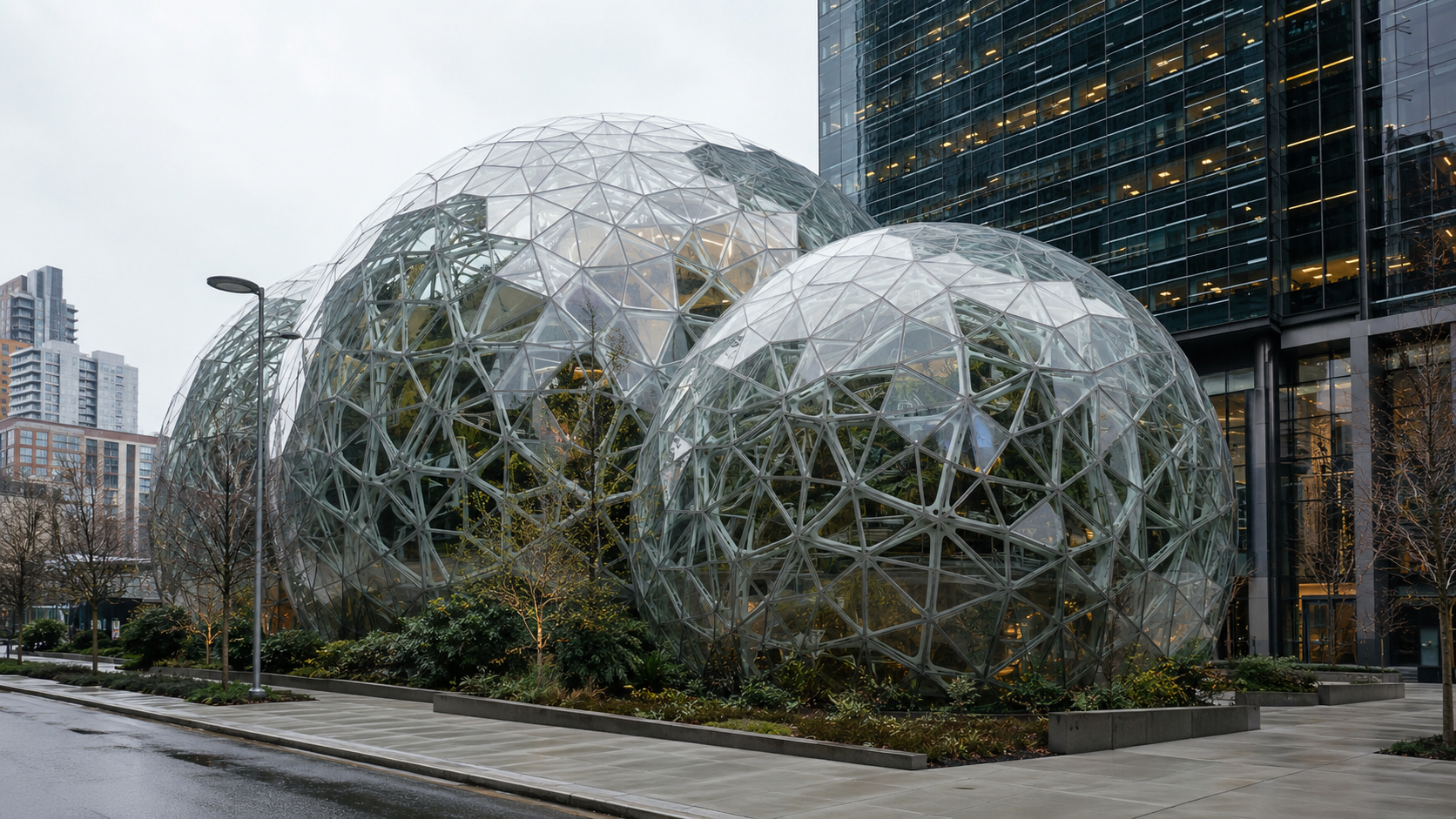Amazon Spheres in Seattle shown as glass geodesic conservatories with interior planting and surrounding urban landscape.