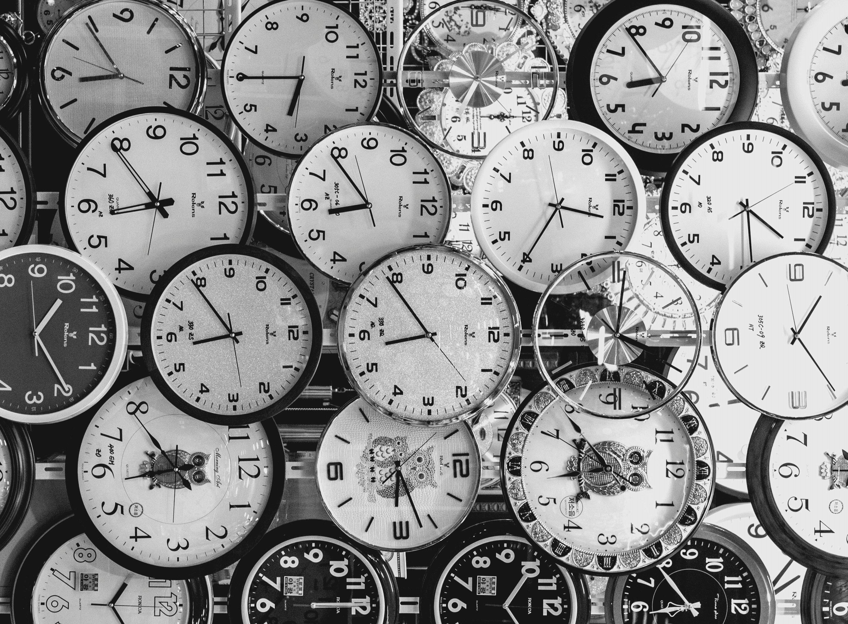  Multiple clocks of various styles representing the importance of time management in architecture.