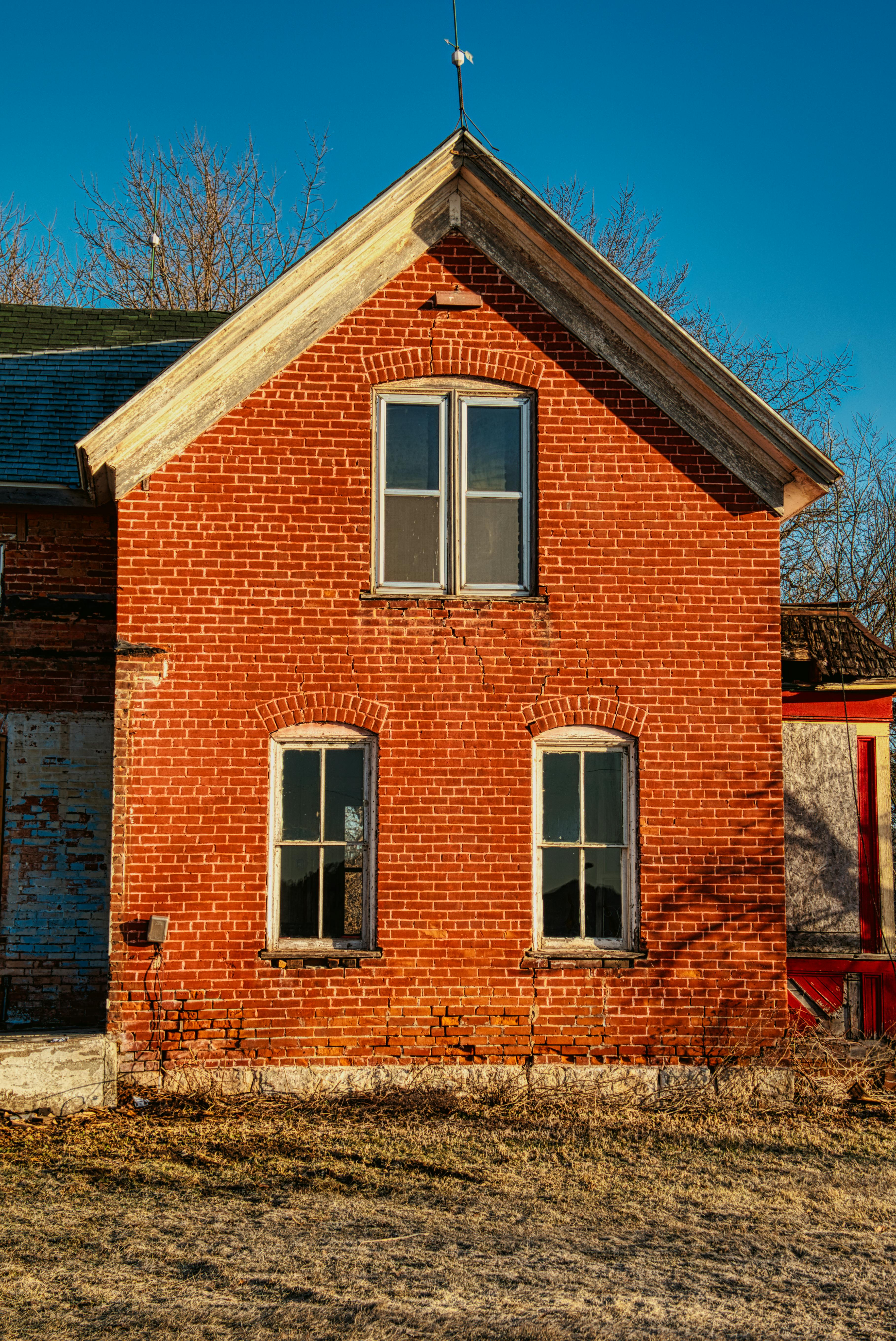 Brown brick house with minor brick damage.