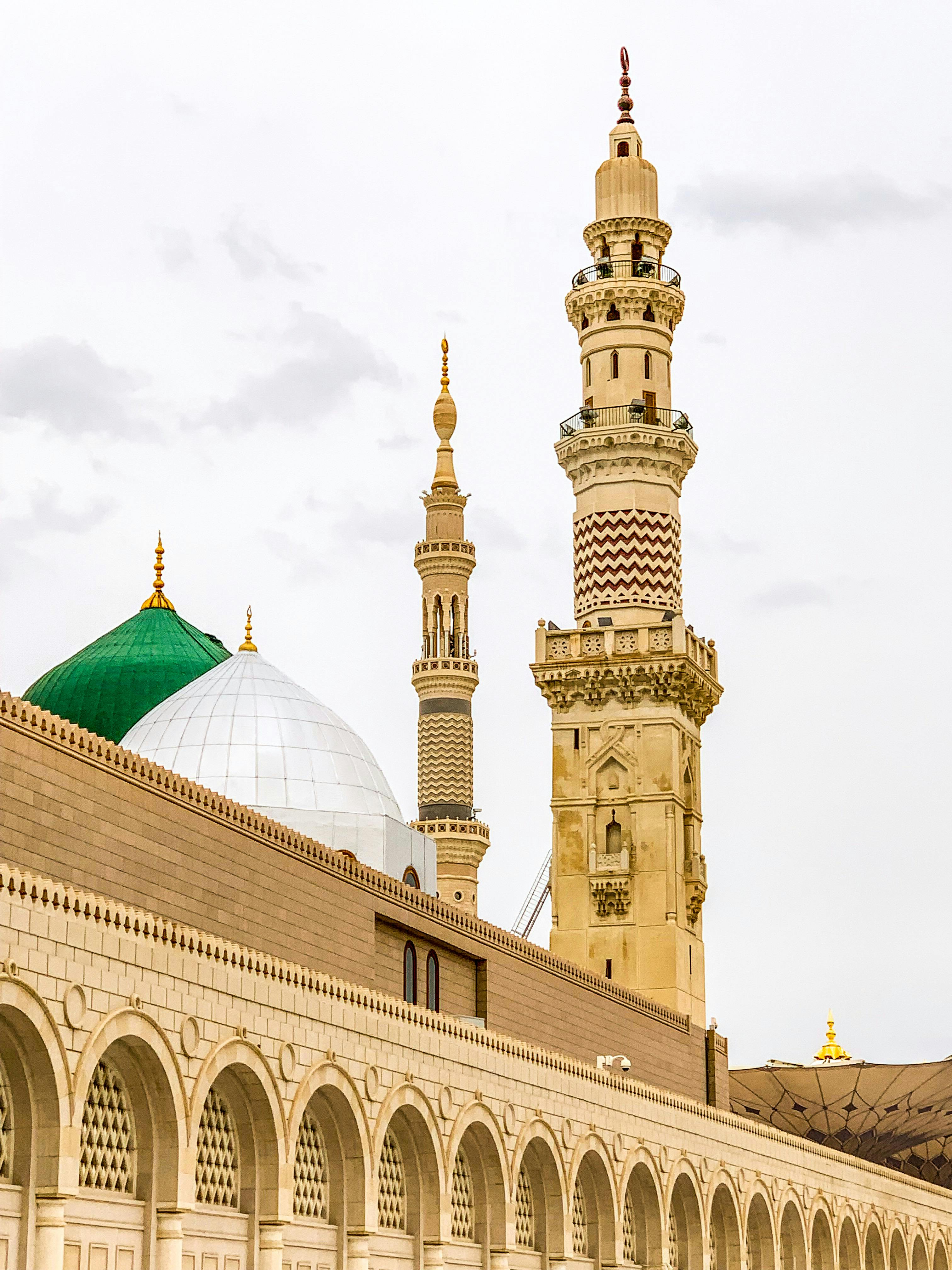 Minarets of the Prophet's Mosque in Medina showcasing classic Islamic architecture.