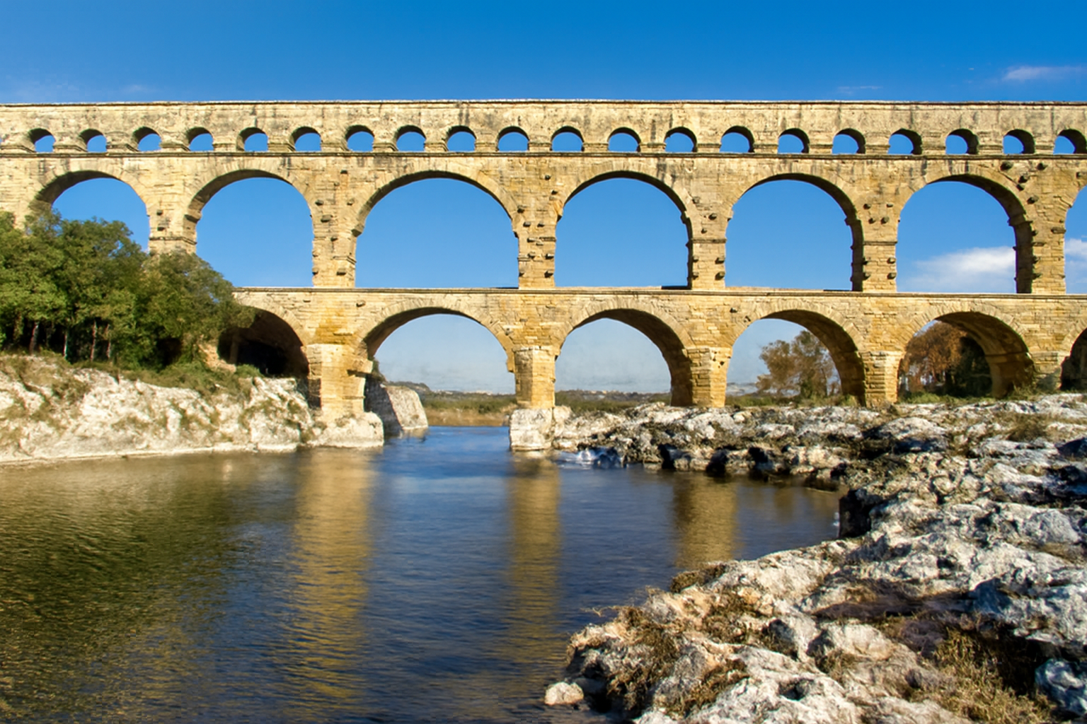 Pont du Gard, a Roman aqueduct with iconic arches spanning the Gardon River.
