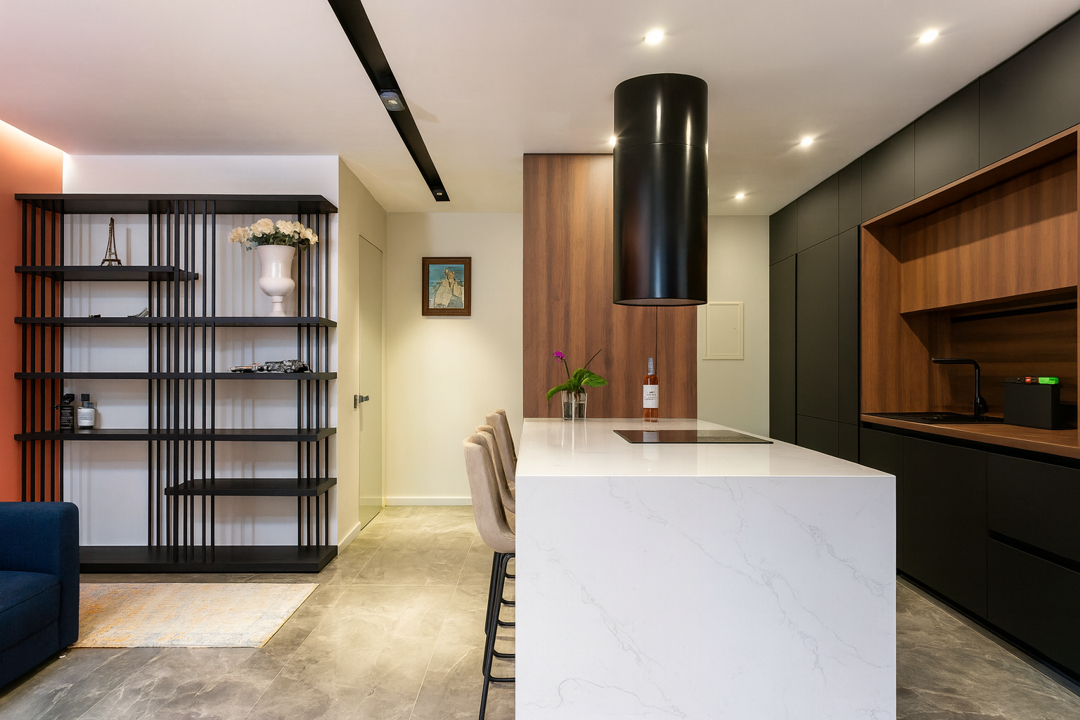 Modern kitchen with black cabinets, wood accents, and a white glossy island countertop.