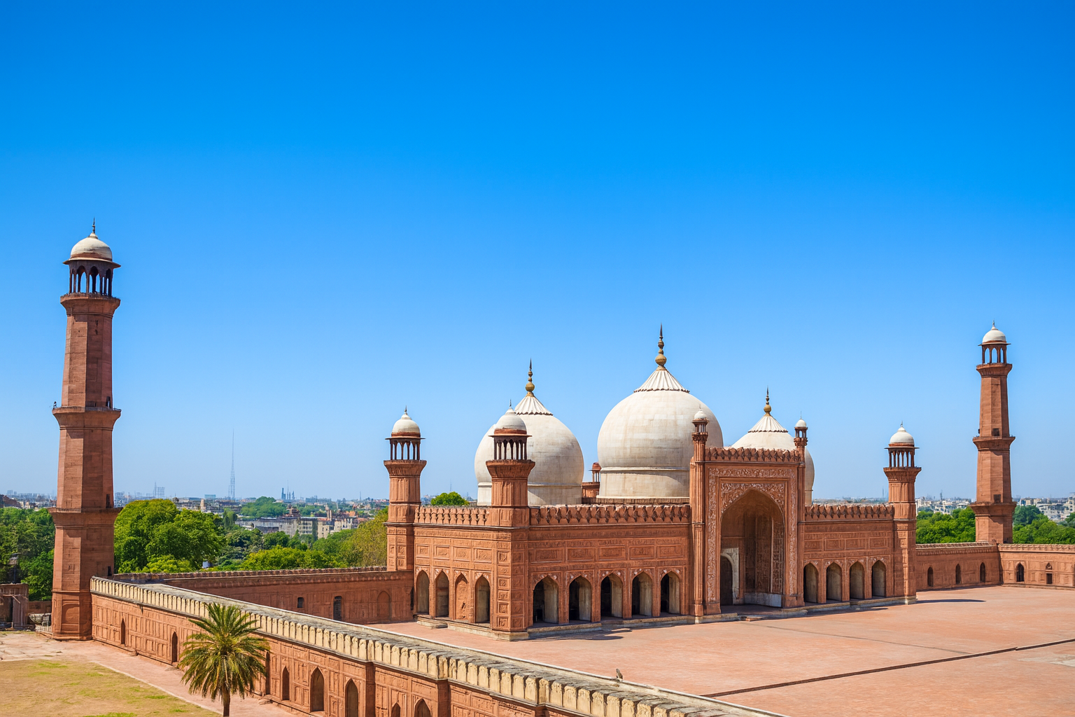 Badshahi Mosque in Lahore with red sandstone walls and marble domes.