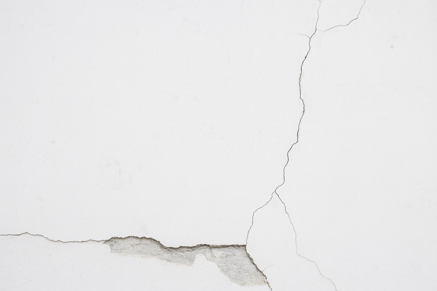 A close-up of cement cracks, highlighting structural surface damage in concrete.