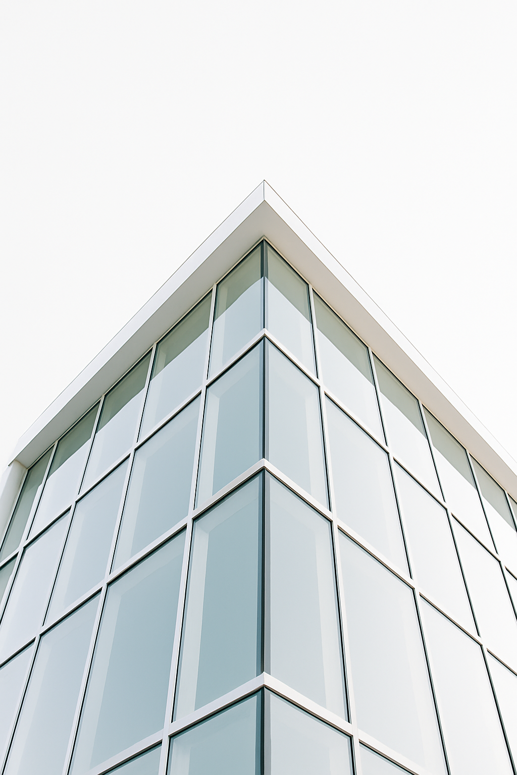 Modern glass building with sharp architectural lines and contemporary design.