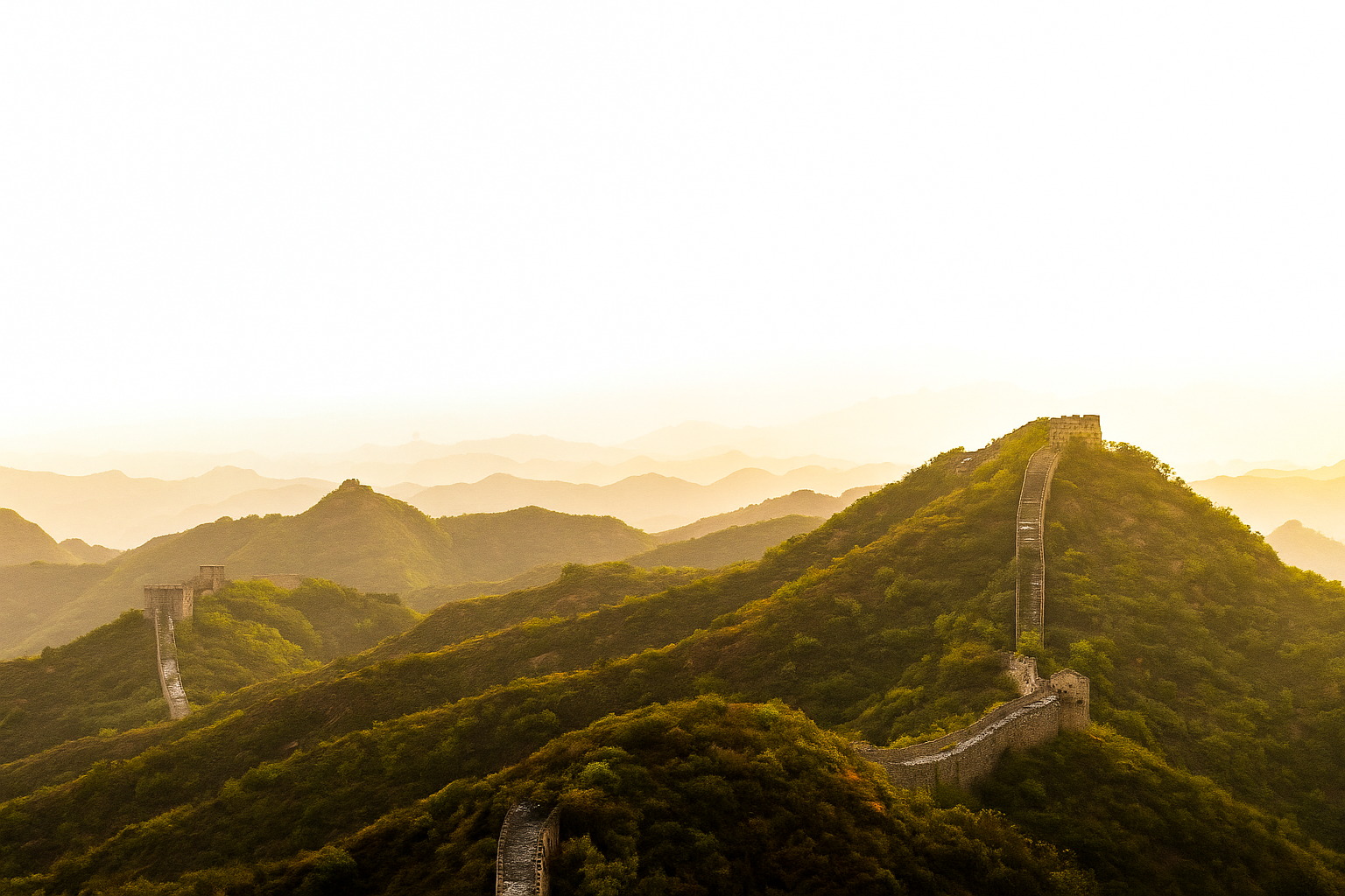 Great Wall of China viewed from a unique angle with sunlight and greenery.