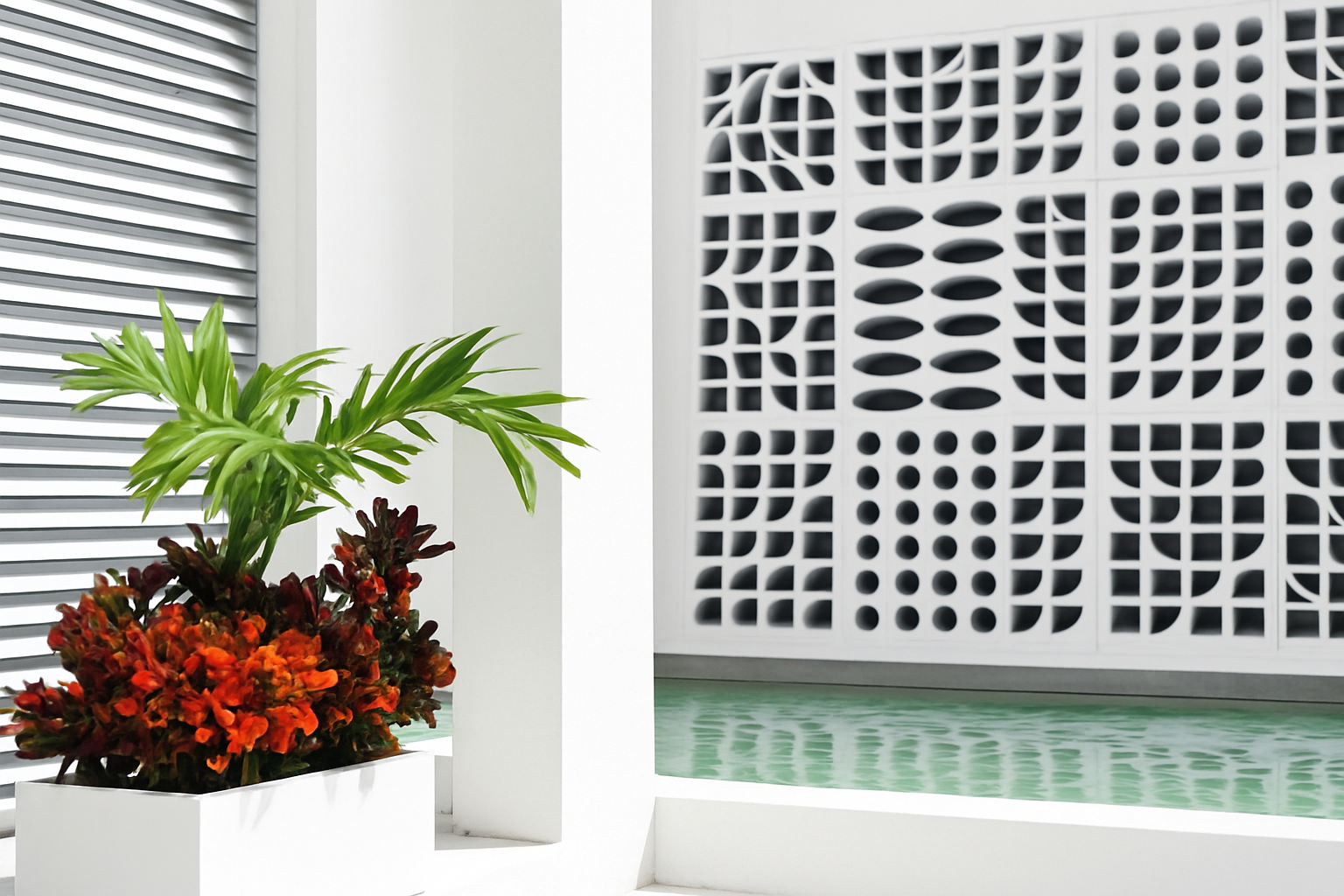 Breeze block wall with tropical planter and water feature in Playa del Carmen, Mexico.