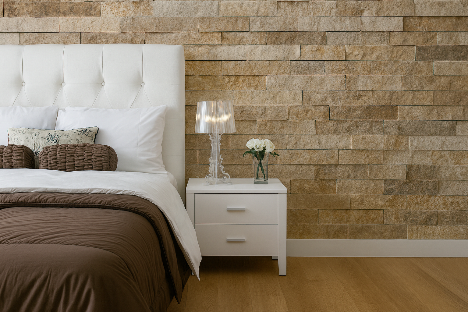 Modern bedroom interior featuring a natural stone accent wall, white headboard, and minimalist decor.