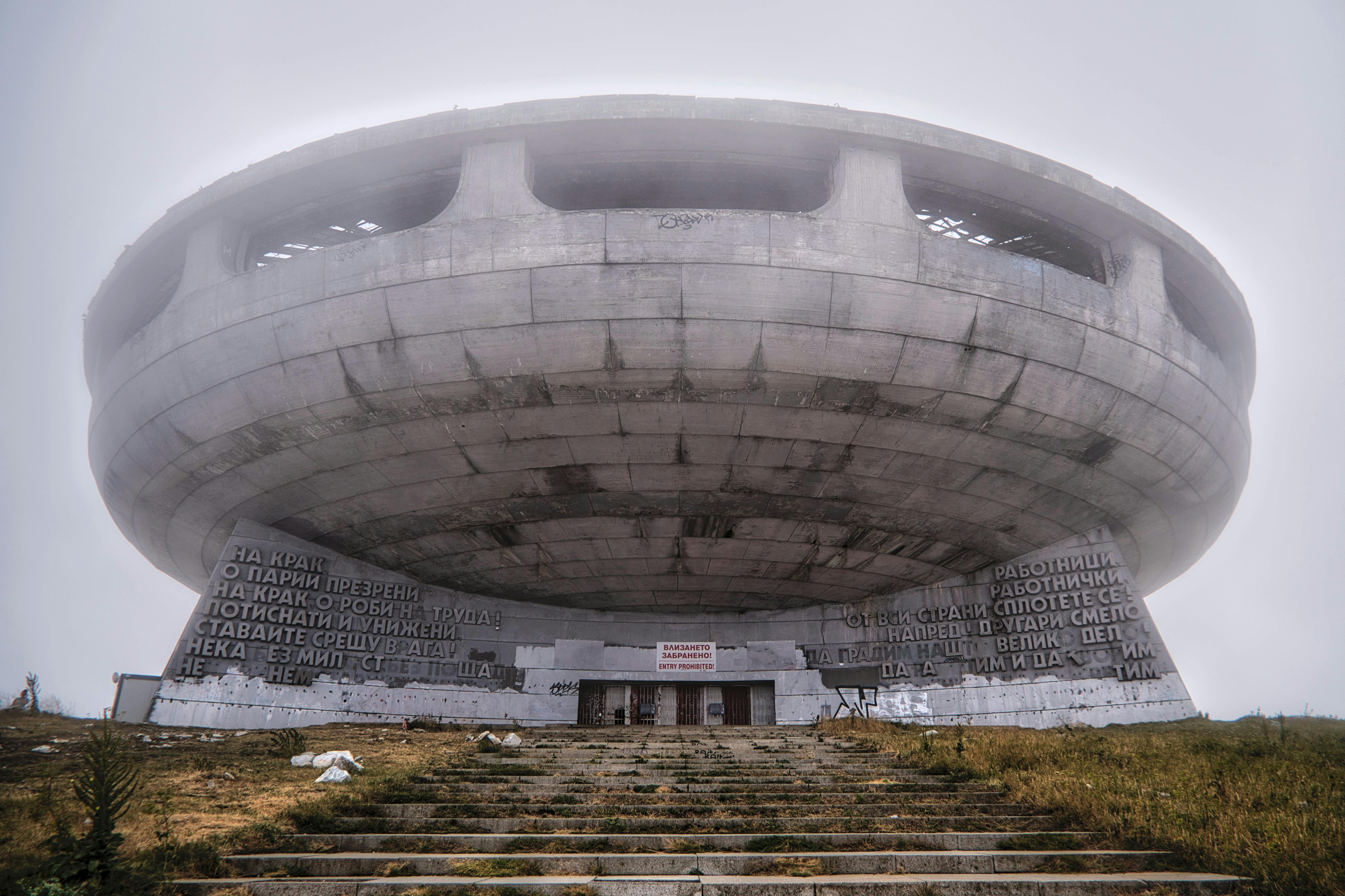 Buzludzha Monument, iconic brutalist structure, emerging from fog in Stara Zagora, Bulgaria.