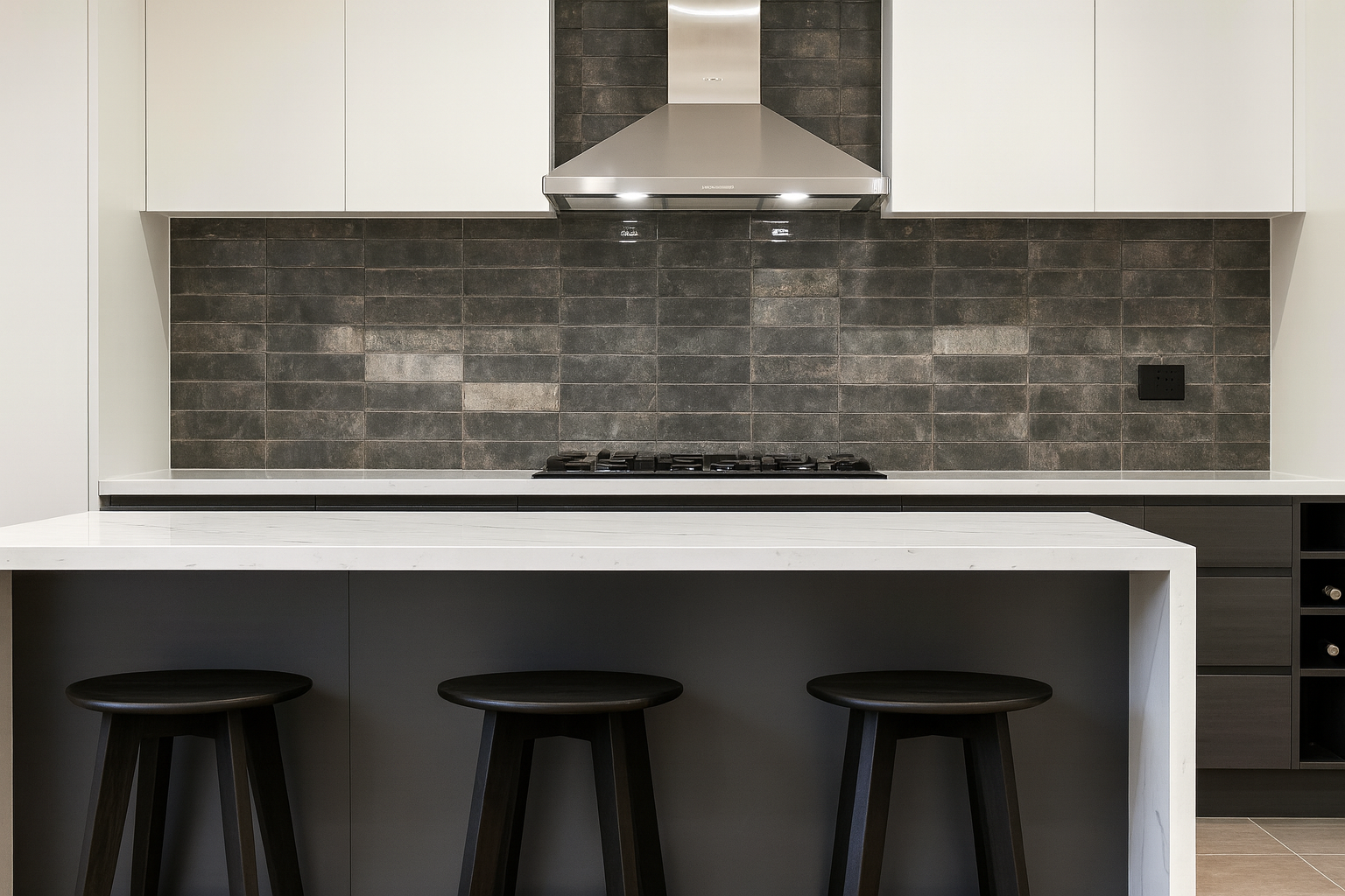 Modern kitchen with engineered stone benchtop, dark tiled splashback, and minimal design.