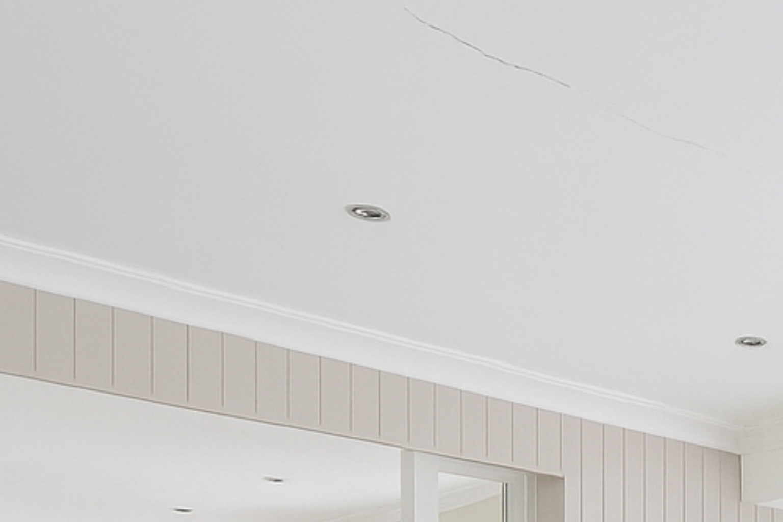 Long visible crack running across a house ceiling.