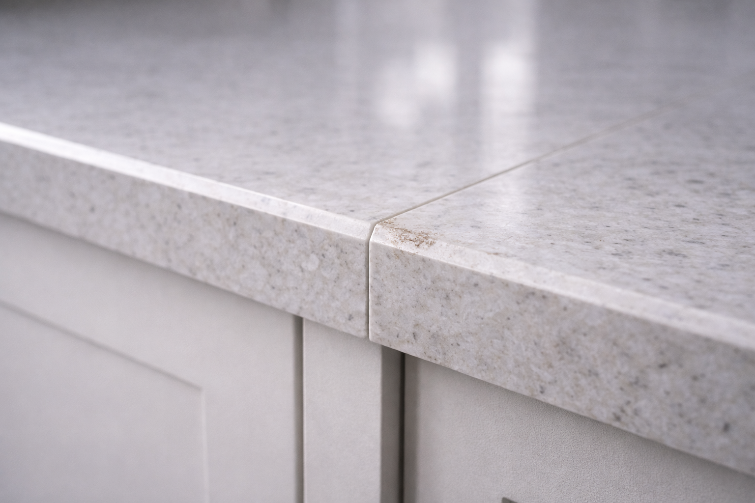 Modern white kitchen island countertop with a subtle bevel edge detail.