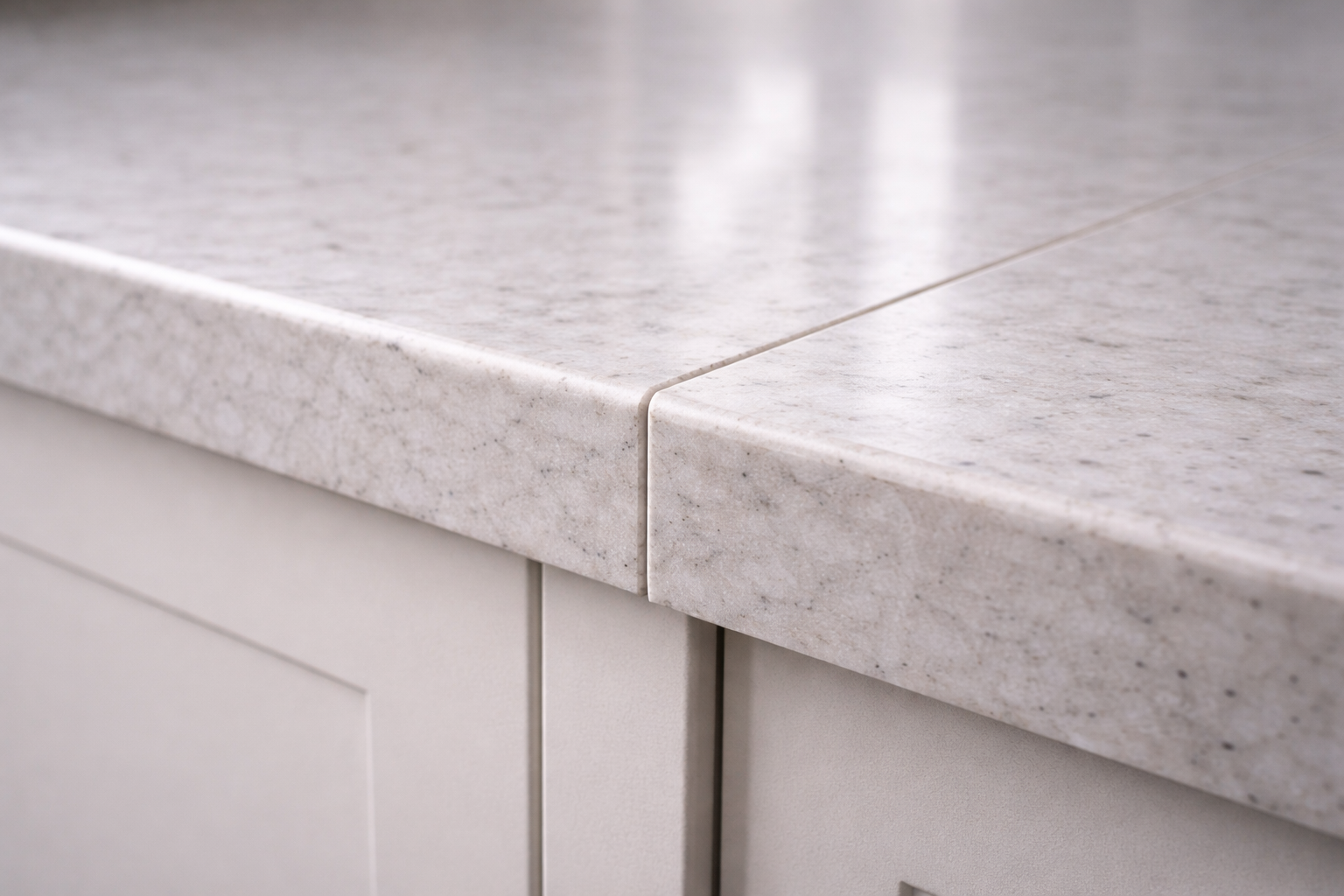Kitchen countertop seam visible in reflected light showing real installation joint.
